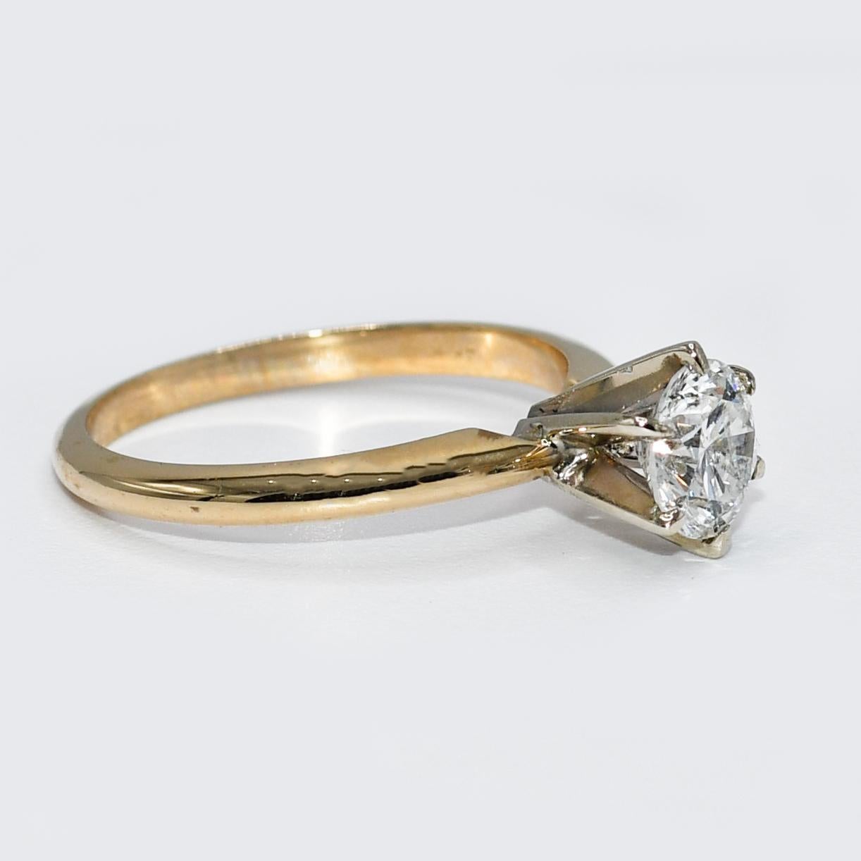 14K Yellow Gold RBC Diamond Solitaire Ring G-H, i1 0.97TDW, 2.8gr

Ladies diamond solitaire ring with 14k yellow gold setting.
Stamped 14k and weighs 2.7 grams.
The diamond is a round brilliant cut, weighing .97 carats, G to H color, i1 clarity,