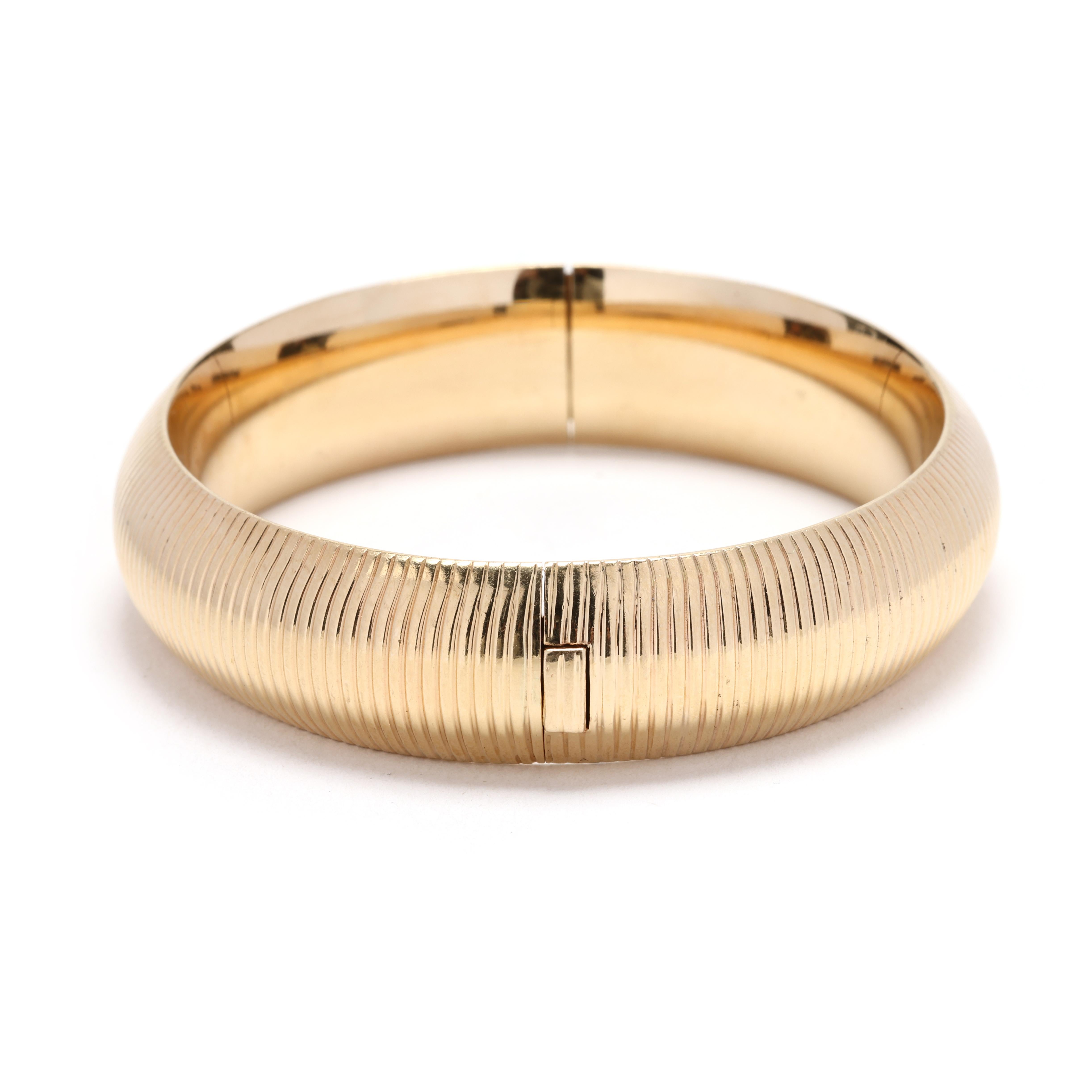 Bangle bracelets are versatile accessories that can add a touch of elegance to any outfit, and this 14k yellow gold ribbed bangle is no exception. Measuring 6.75 inches in length and boasting a thick design, this bangle makes a bold statement on the