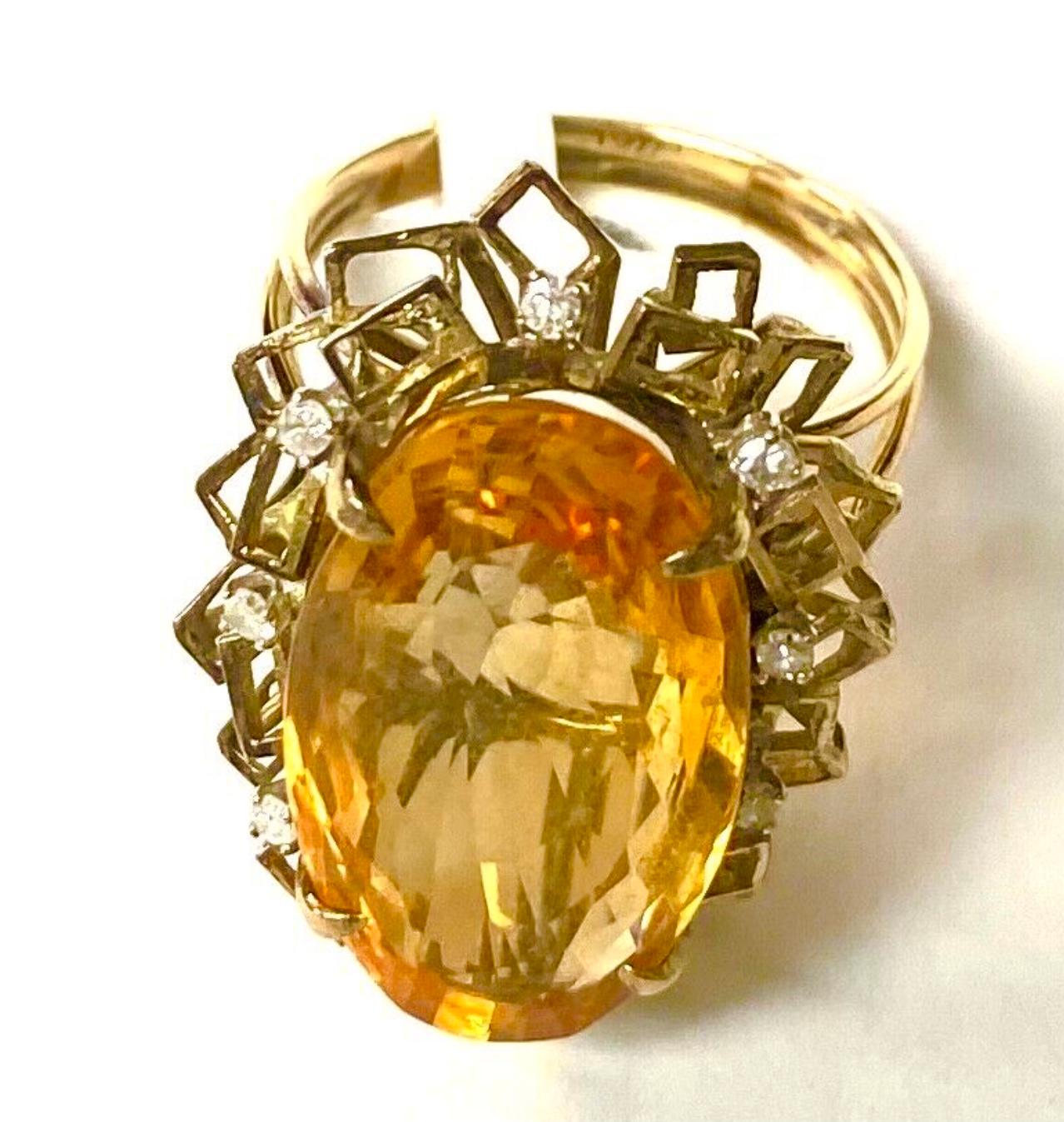 14k yellow gold Citrine and diamond ring, 10.32 Grams TW. The dimensions of the oval Citrine are approximately 30 mm x 15 mm. Approximately 15 carats. Marked14k. Approximate size 10.