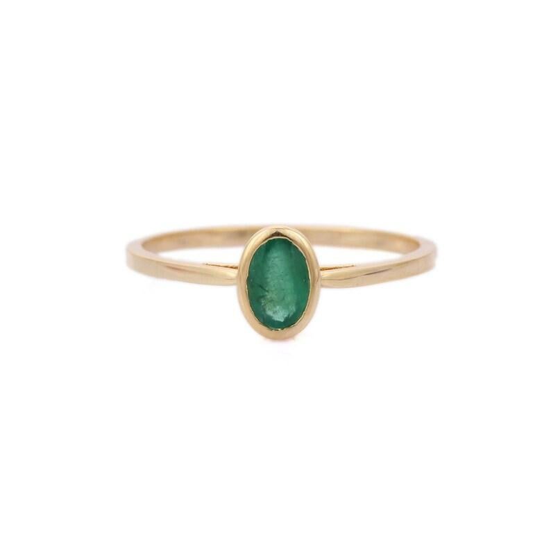 Handcrafted Dainty Emerald Ring in 14K Gold featuring natural emerald of 0.59 carats. The gorgeous handcrafted ring goes with every style. To enhance your look and convey your emotions, stack your rings.
Emerald enhances the intellectual capacity of