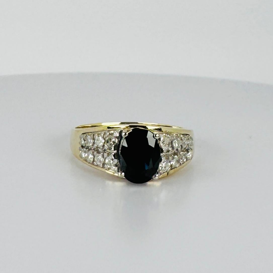 Check out the unique shape and stunning design of this pre-loved 14k ring! Featuring a beautiful dark blue sapphire with sparkling brilliant cut diamonds. This ring is all about making a statement. Don’t miss out—add this standout piece to your