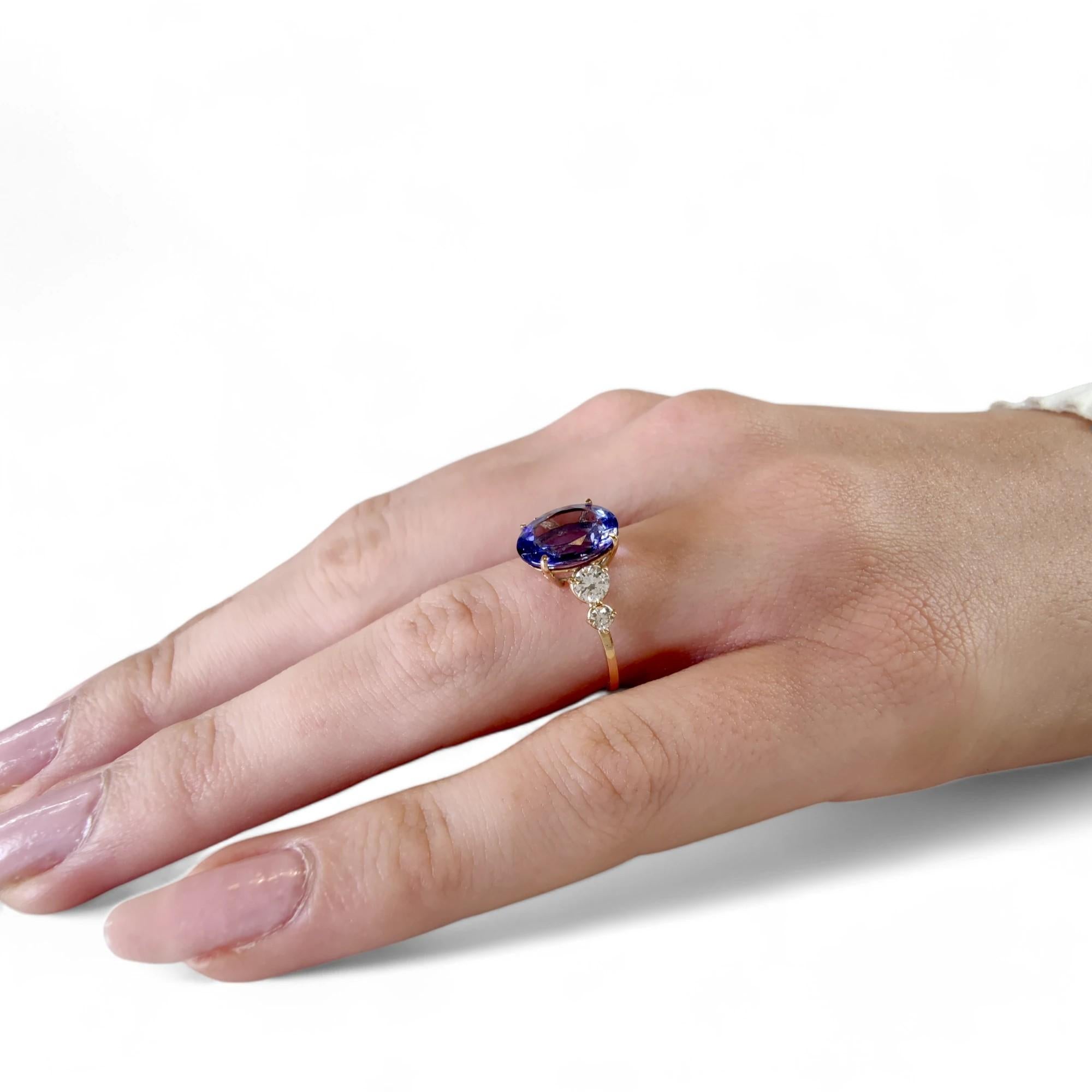 14K Gold Ring with Oval Tanzanite and Diamonds

Experience the exquisite allure of our 14K gold ring, masterfully crafted with a central oval Tanzanite encircled by sparkling diamonds. This contemporary piece is a testament to skilled artisan