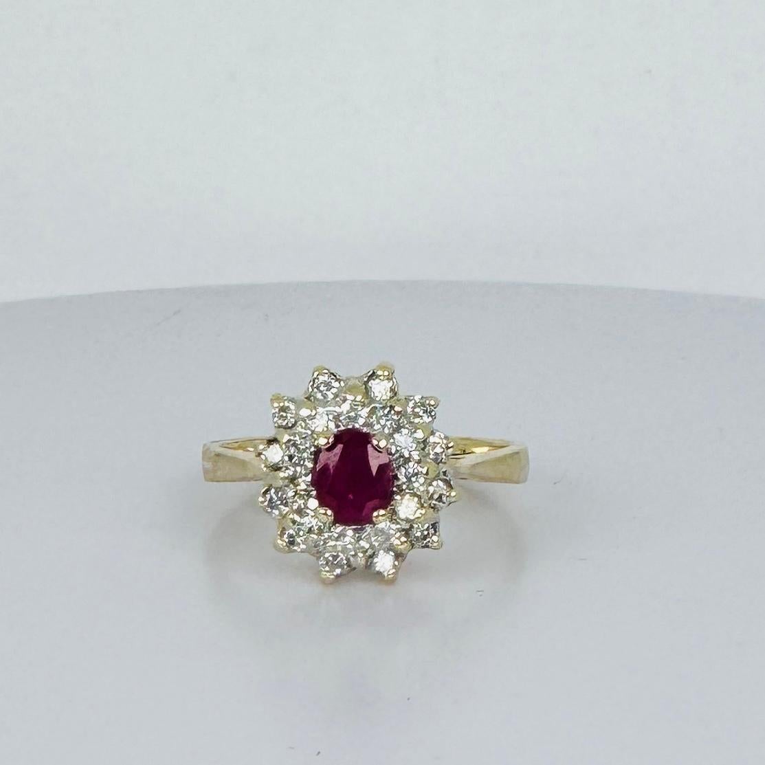 This exquisite entourage ring is crafted from 14 carat yellow gold, featuring a stunning natural ruby and brilliant cut diamonds. The vibrant ruby is the centerpiece of this gem, surrounded by 24 brilliant cut diamonds, creating a dazzling display