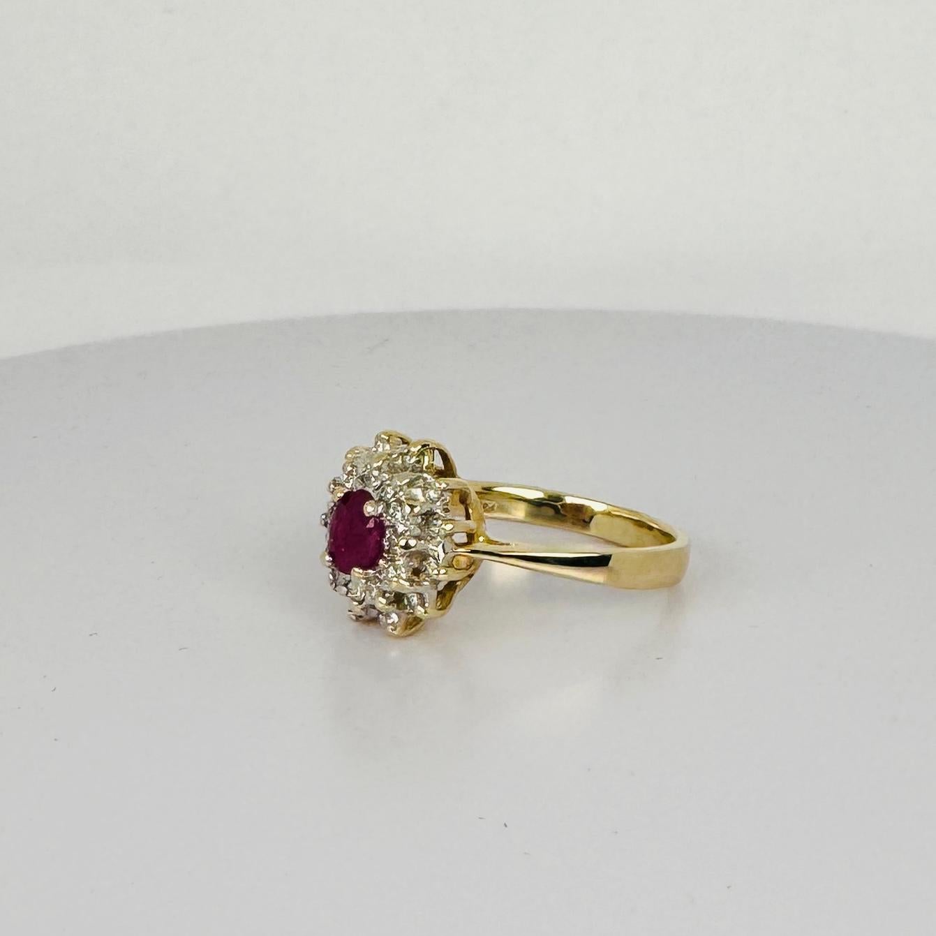 14k yellow gold ring with oval cut natural ruby and 24 brilliant cut diamonds In Good Condition For Sale In Heemstede, NL