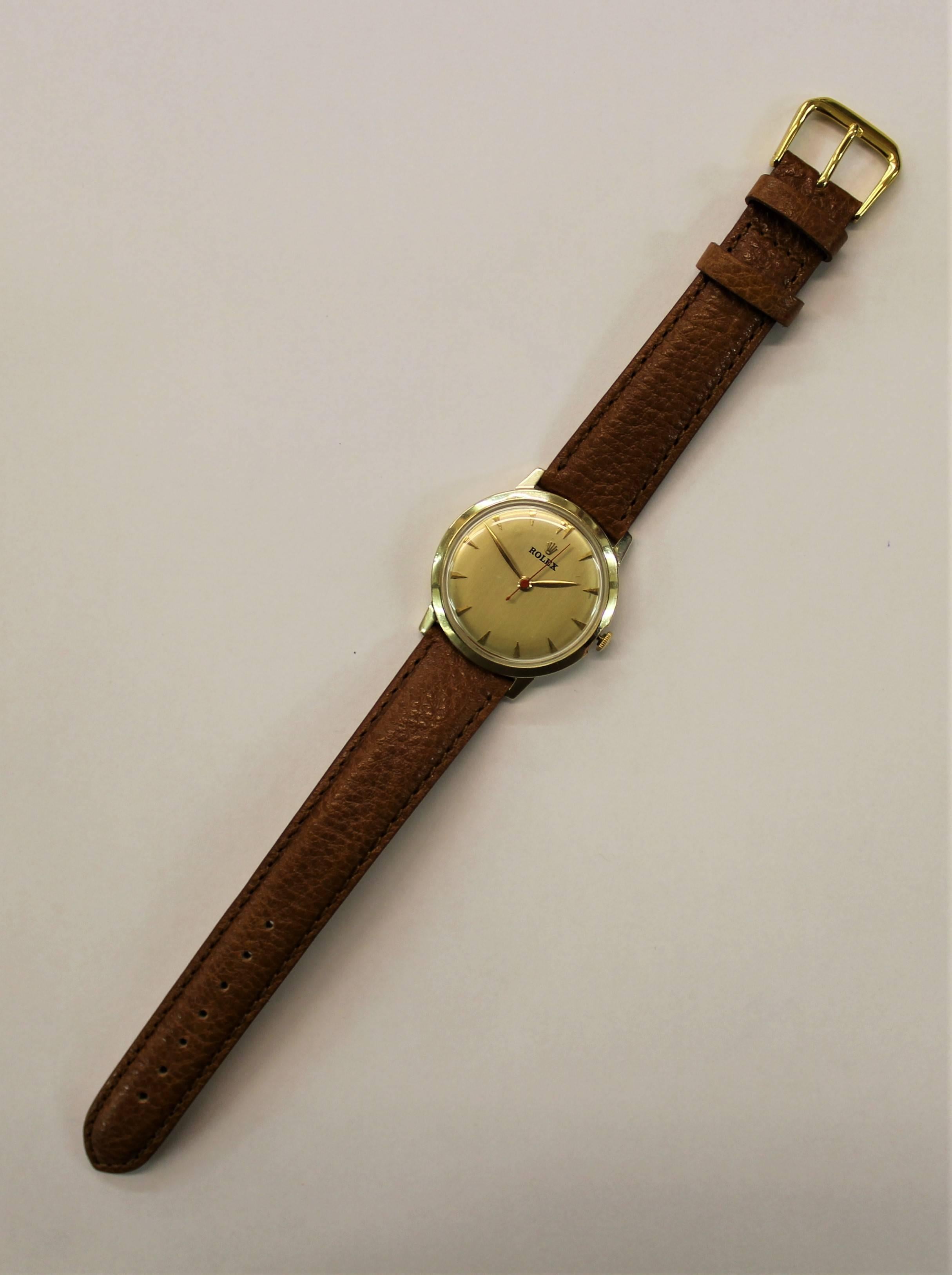 14-karat yellow gold Montres Rolex Geneva Swiss watch with a genuine calfskin leather strap, circa 1945.
-17 jewels
-Model number 1210
- Weight of case 10.8 grams
-Measure: Case diameter 33 mm
-Crown size 4.2 mm
-Height 9.5 mm
-Serial number