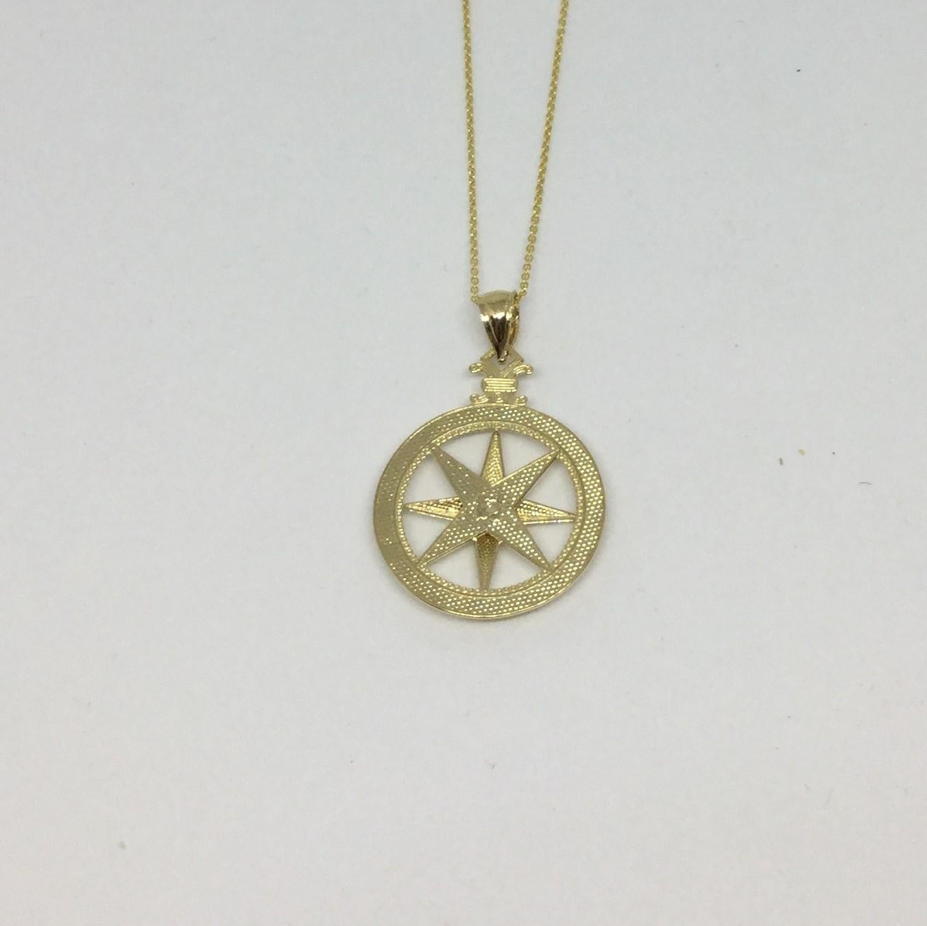 14K Yellow gold rose compass pendant necklace. The compass is 0.75 inches in diameter. The chain is 16 inches in length.