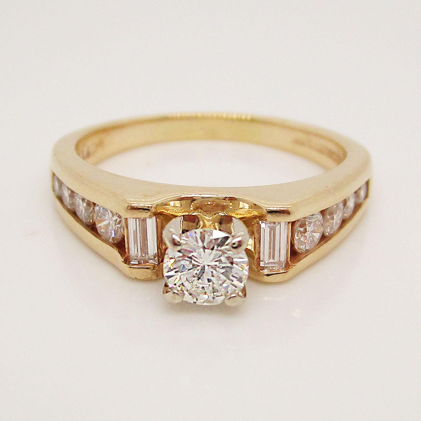 This absolutely beautiful ring is in 14k yellow gold and has a stunning collection of baguette and round diamonds to accent the brilliant white round center stone. This ring has the classic beauty of a traditional engagement ring but is made unique