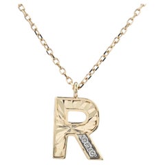 Collana con ciondolo a forma di "R" in oro giallo 14 carati con diamante a taglio rotondo