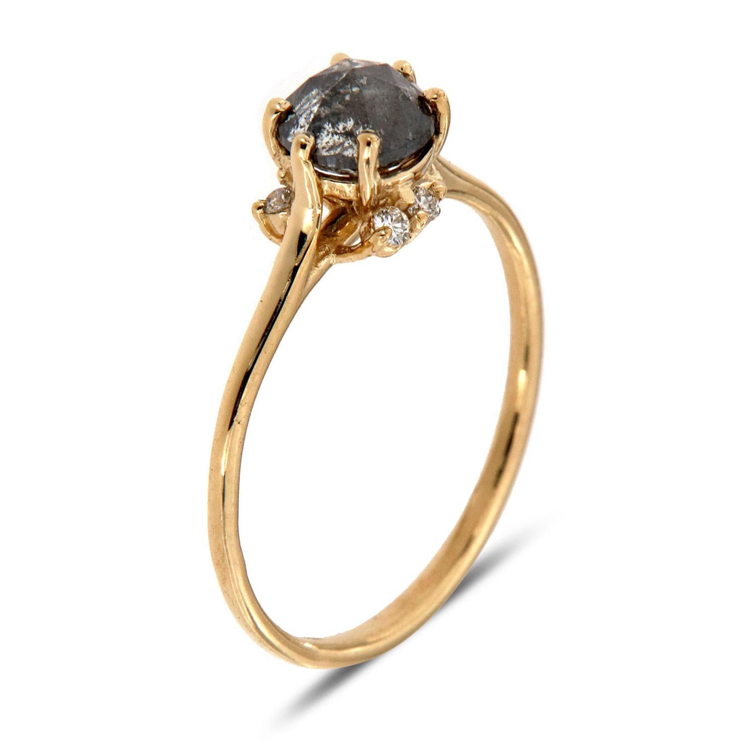 This earthy-designed ring features a 0.75 Carat Salt and Pepper round diamond set between Six (6) tiny prongs. Four(4) round brilliants diamonds unevenly scattered underneath its crown create the ultimate organically feel. The ring sizable and can