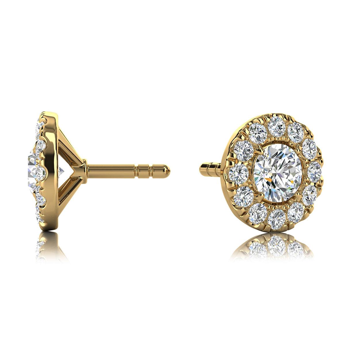 These delicate earrings feature two round shaped diamonds that are approximately 0.30-carat total weight (3.3mm) encircled by a halo of perfectly matched 32 round brilliant diamonds in about 0.20-carat total weight. The earrings are measuring at 6.7