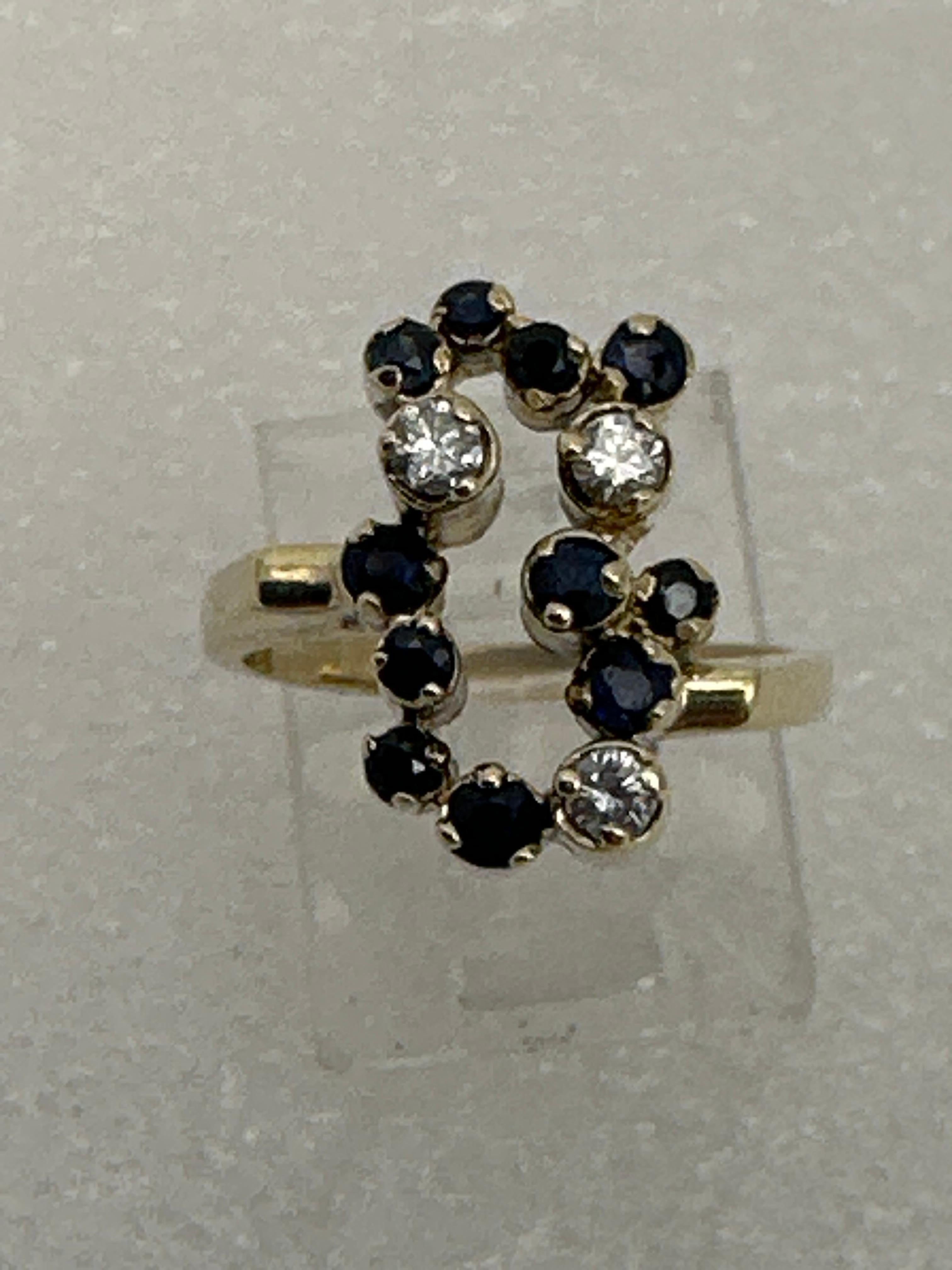 14kt Yellow Gold  ~  High Set ~ Round Sapphires and Diamonds ~ Cocktail Fun Ring ~ Size 6 1/4
Made up of:
11 ~ sapphires approx 1.5mm to 2.4mm
 3 ~ Diamonds approx 2.5mm
Made in NY ~ Stamped 14k SKAL 
Cut and different Sapphire is the birthstone for