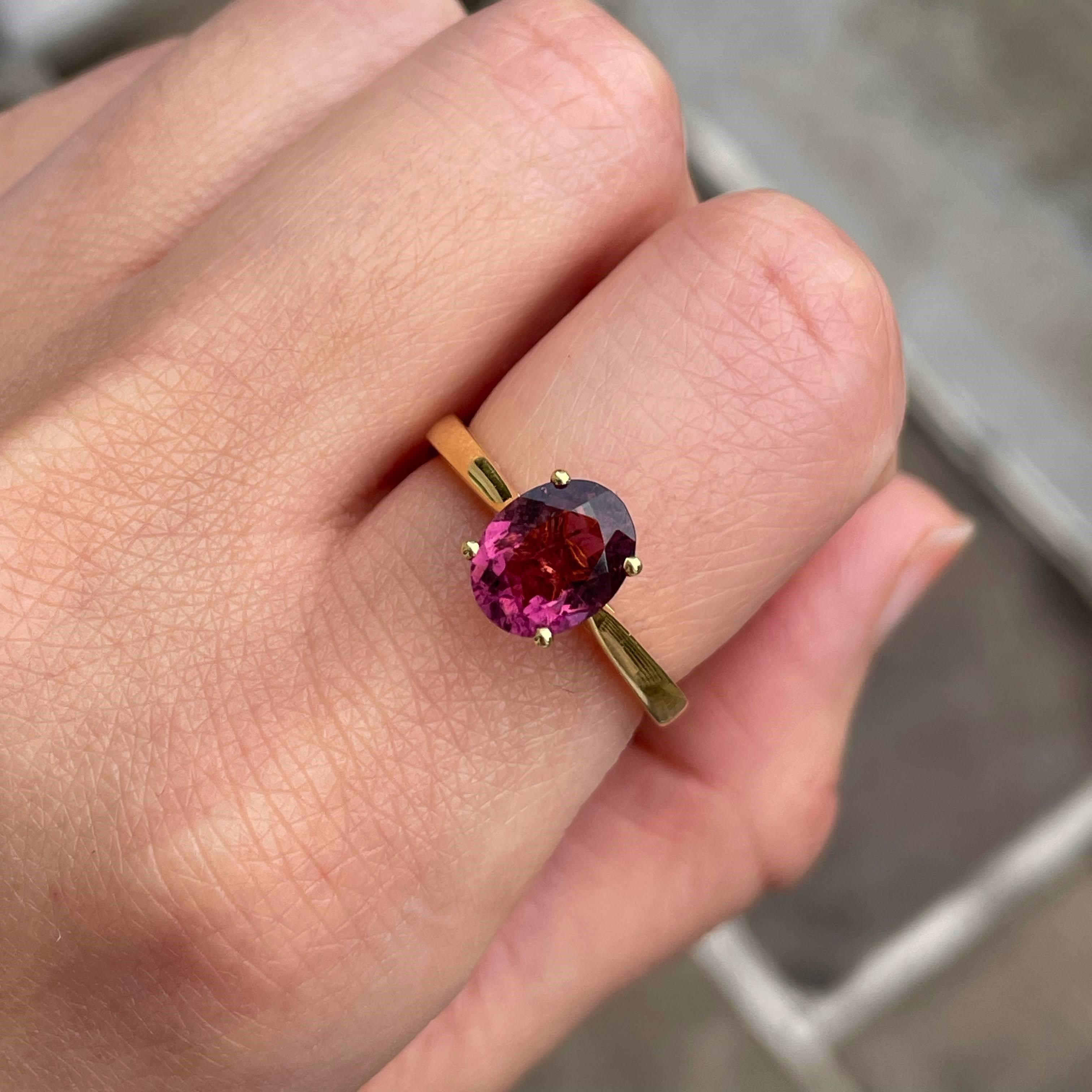 This rubellite ring is simple yet stunning. Featuring an oval cut deep colored center stone, this Rubellite ring is the epitome of elegant jewelry. Rubellite is the rarest of Tourmaline. An everyday stunner, this ring is one of our favorites in our
