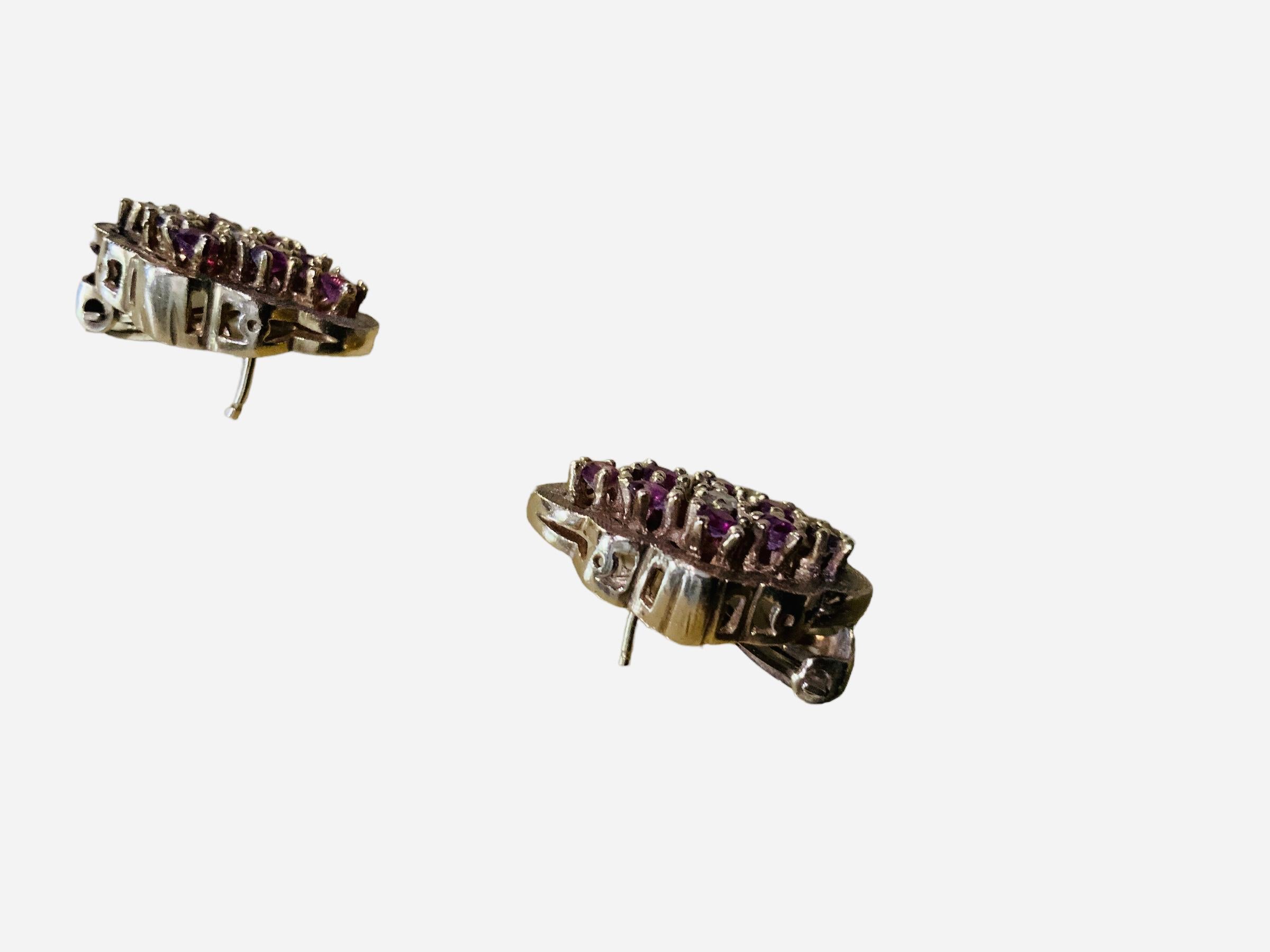 This is a pair of 14K yellow gold, lab created rubies and diamonds earrings. They are finely shaped as an octofoil. Eight rubies ( 2.7 cm in diameter each one ) are exquisitely arranged in prong setting together with a diamond ( 2cm in diameter each