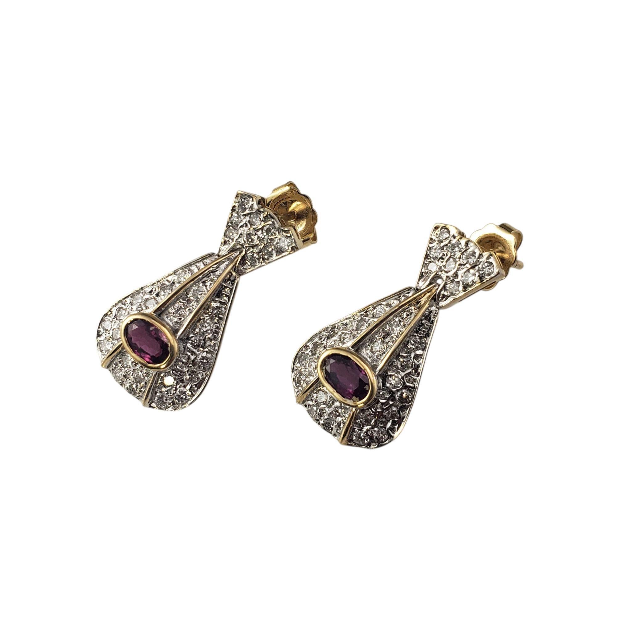 14K Yellow Gold Ruby and Diamond Door Knocker Earrings JAGi Certified-

Elegant and timeless, these 14K yellow gold earrings each feature one oval shaped natural ruby and 36 round brilliant cut diamonds, creating a spectacular combination of color