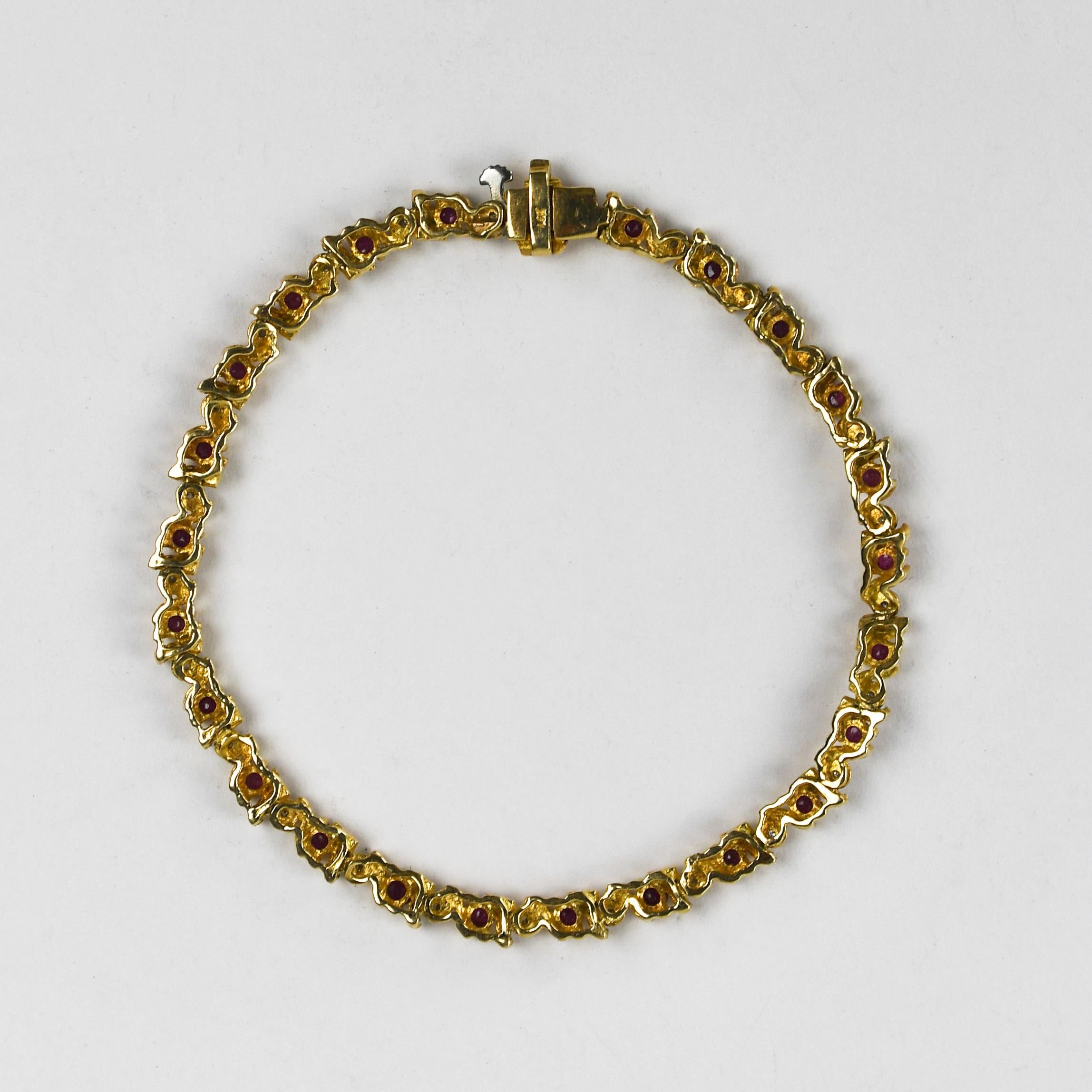 14k yellow gold, ruby and diamond tennis bracelet.
Stamped 14k and tests 58% gold.
Gross weight is 7.8 grams.
There are round, natural rubies 1.00 total carats, good color.
In between the rubies are tiny diamonds, .05 total carats.
The bracelet