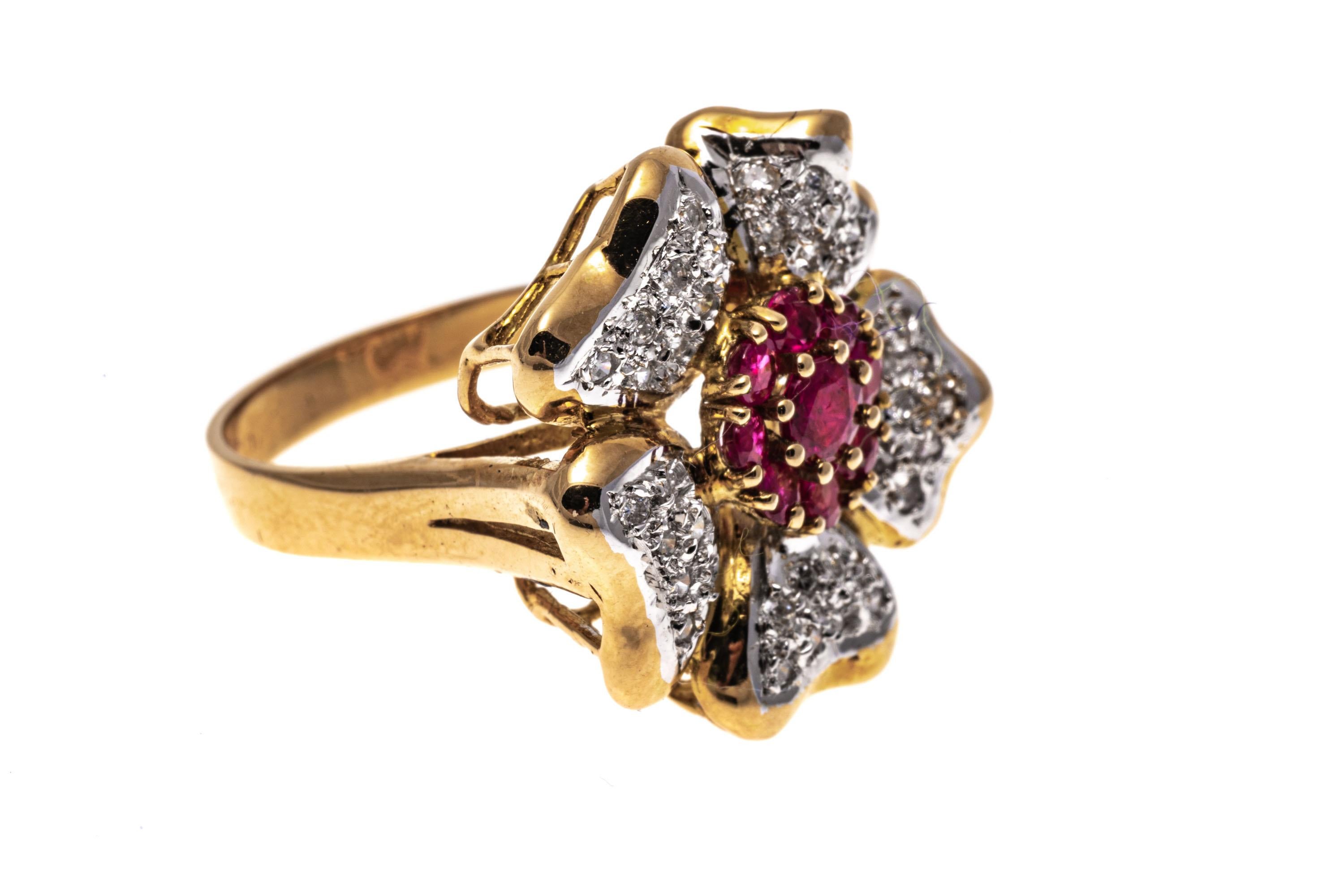 14k yellow gold ring. This fabulous flower motif ring is set with a center cluster of round faceted, reddish pink rubies, approximately 0.85 TCW, prong set and surrounded by five pave set, round faceted diamond petals, approximately 0.19 TCW,
