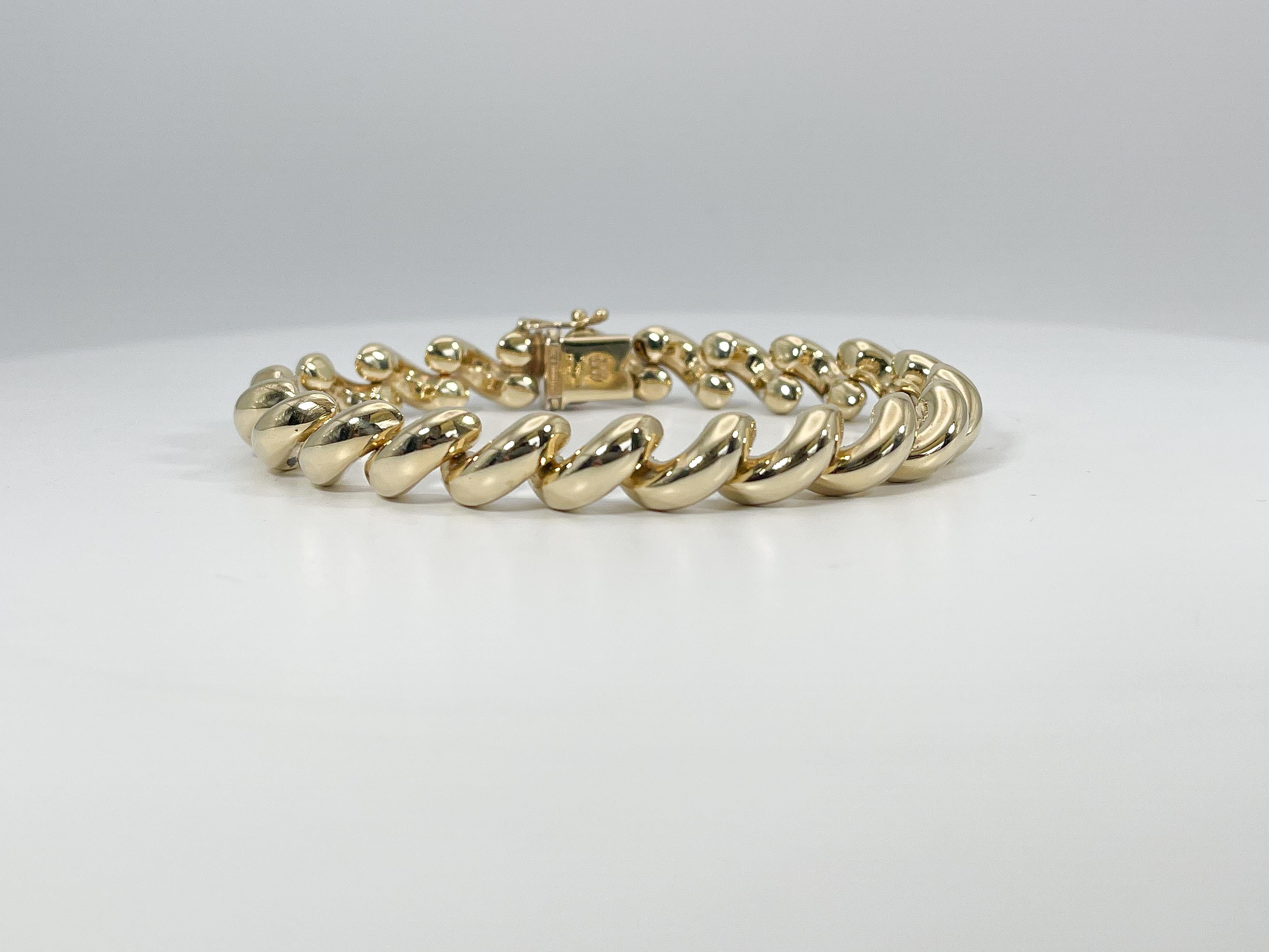 14k yellow gold San Marco Bracelet. This bracelet has a figure 8 clasp to open and close, the width is 9.7 mm, the length is 8 inches, and it has a total weight of 26.5 grams.