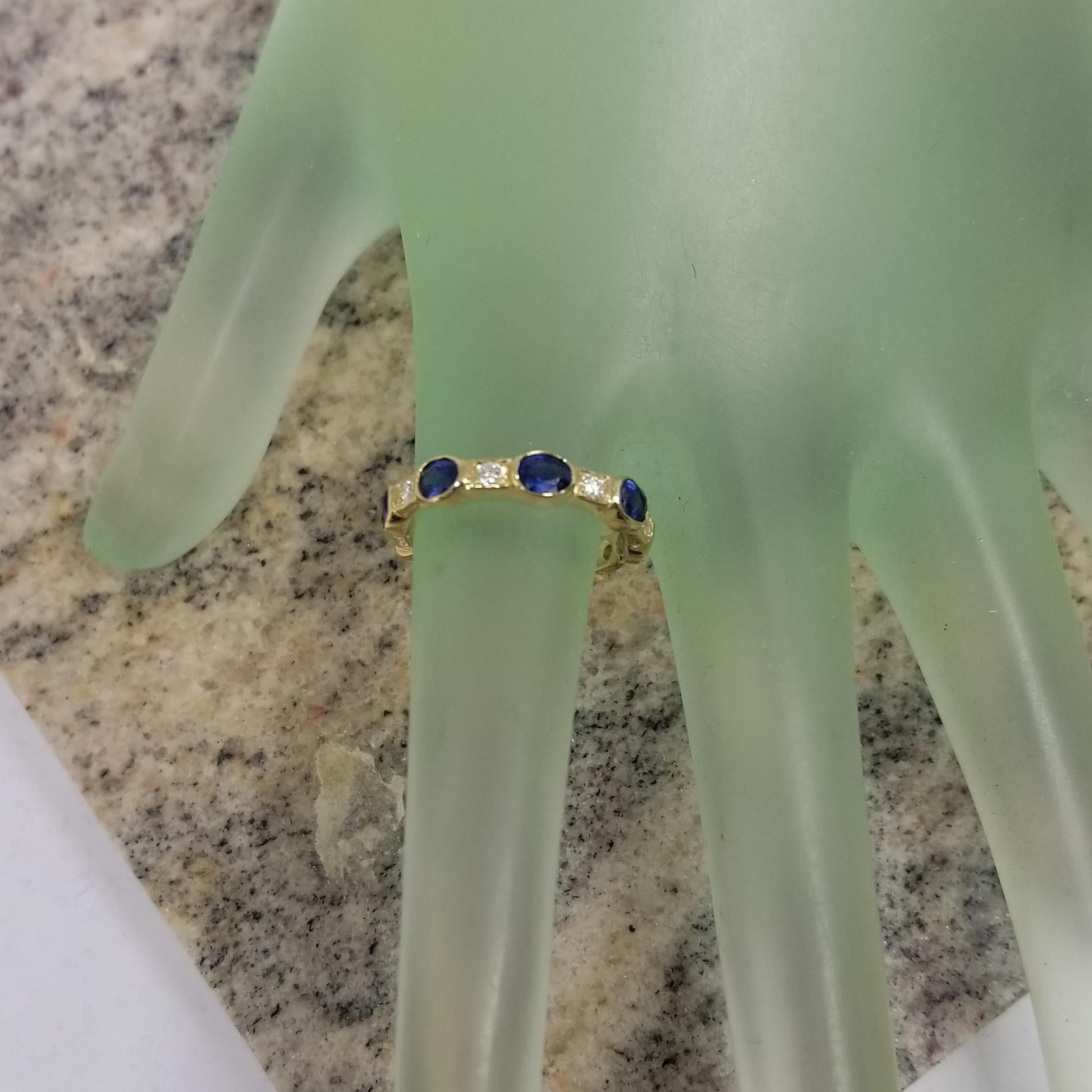 Oval Cut 14k Yellow Gold Sapphire and Diamond Bezel Set Eternity Ring For Sale