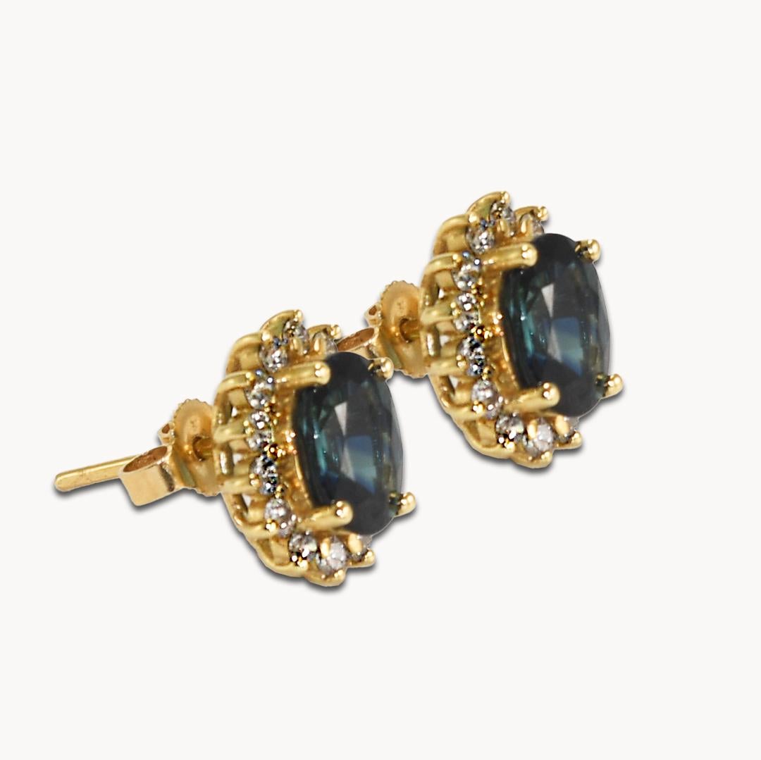 Blue sapphires and diamond earrings in 14k yellow gold settings.
Stamped 14k and weighs 3.4 grams gross weight.
The oval blue sapphires are approximately, 3.00 total carats, dark blue color.
The side diamonds are round brilliant cuts, .50 total
