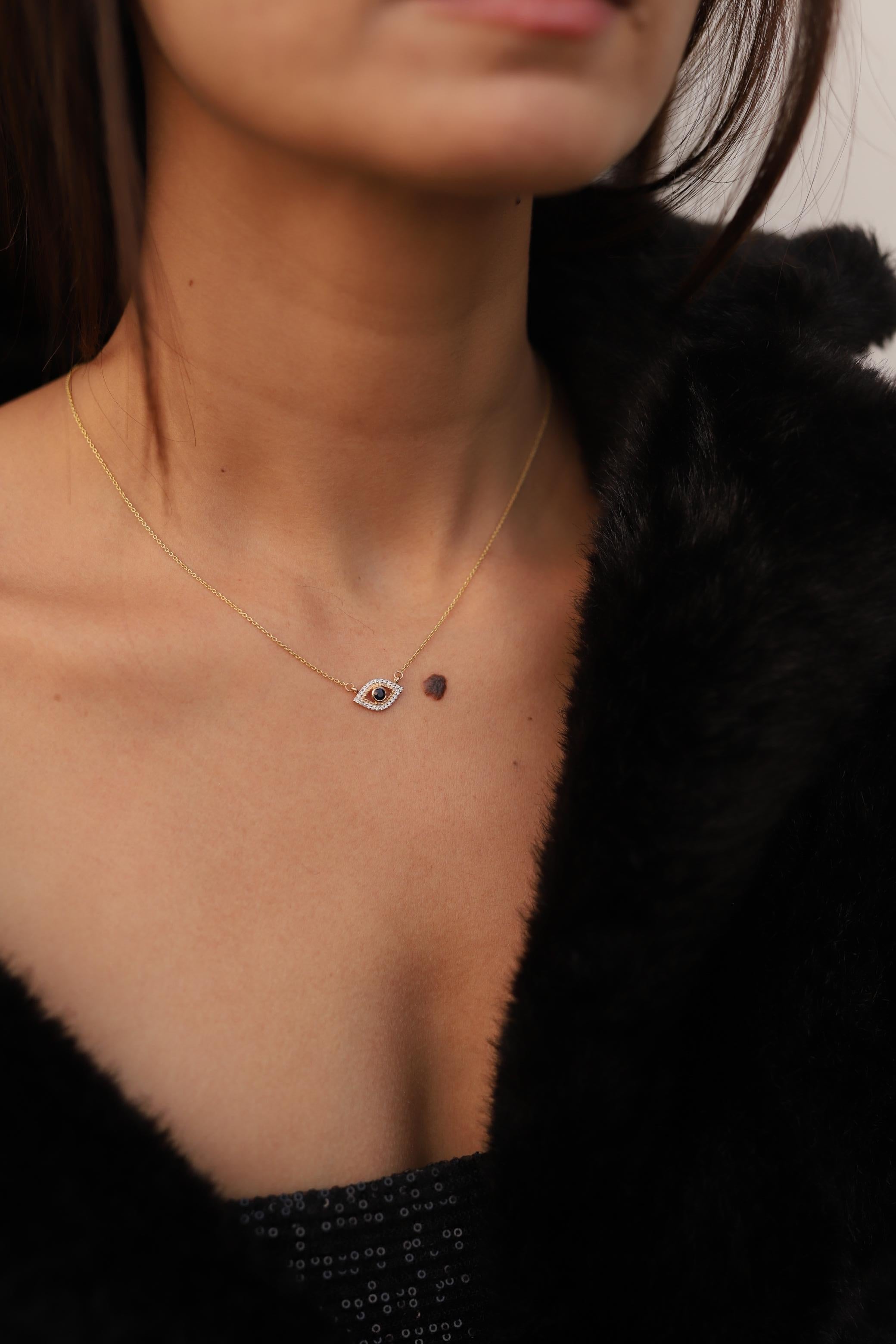 Evil eye sapphire and diamond necklace in 14K Gold studded with round cut diamonds. These are a great bridesmaid, wedding or christmas gift for anyone on your list.
Accessorize your look with this elegant evil eye sapphire pendant necklace. This