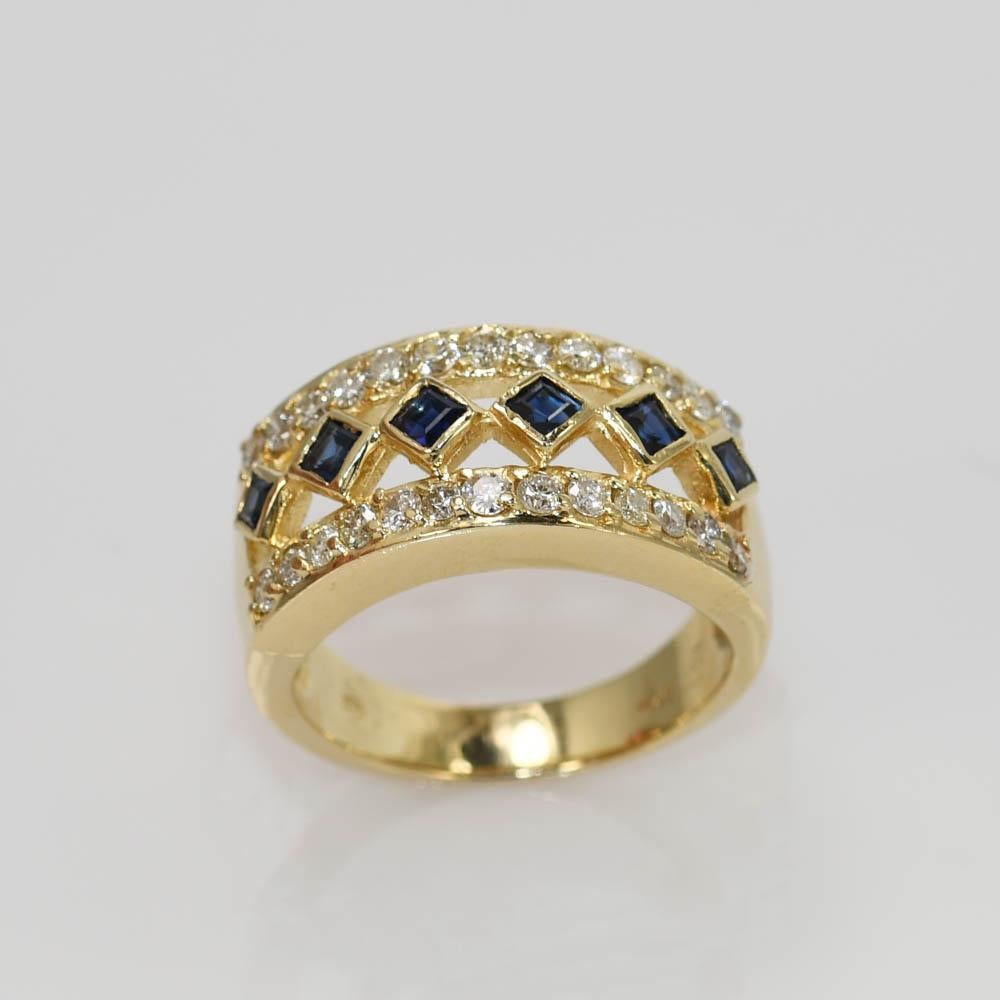 Ladies sapphire and diamond band in 14k yellow gold.
Tests 14k and weighs 8.2 grams.
There are 6 dark blue sapphires in the center of the ring, 0.50 total carats.
The diamonds are round brilliant cuts, .75 total carats, i color, Si clarity.
The ring