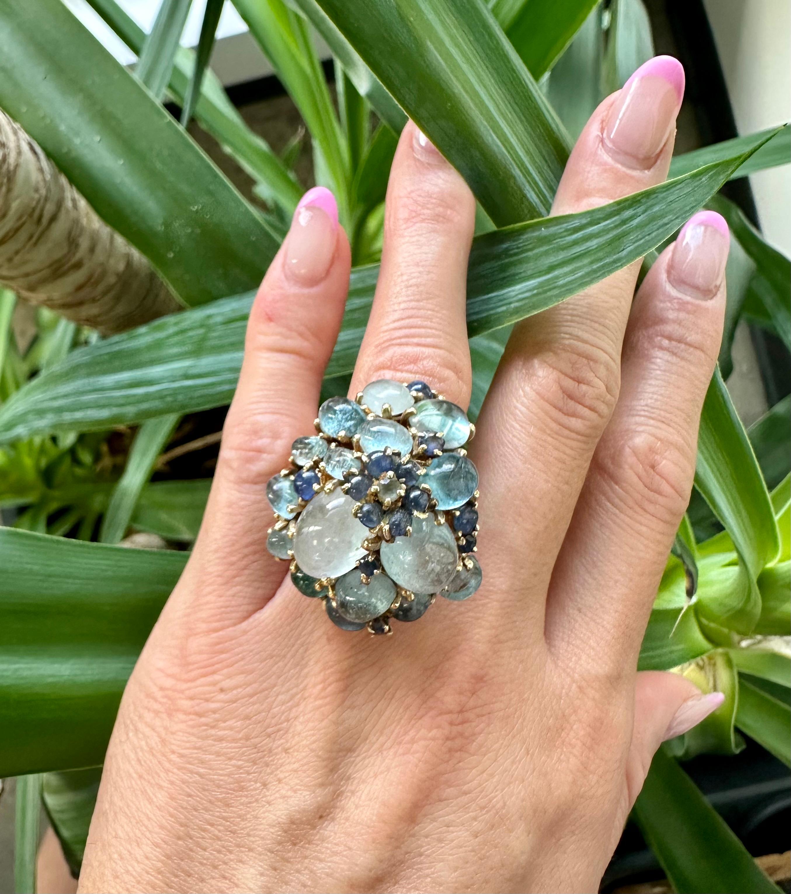 This is defiently the most unique ring you will ever own!
Made of 14k gold and multiple cabochon cut sapphires and moonstones this is a big statement piece that will turn heads.
The colorful combination can be admired from a distance and the design