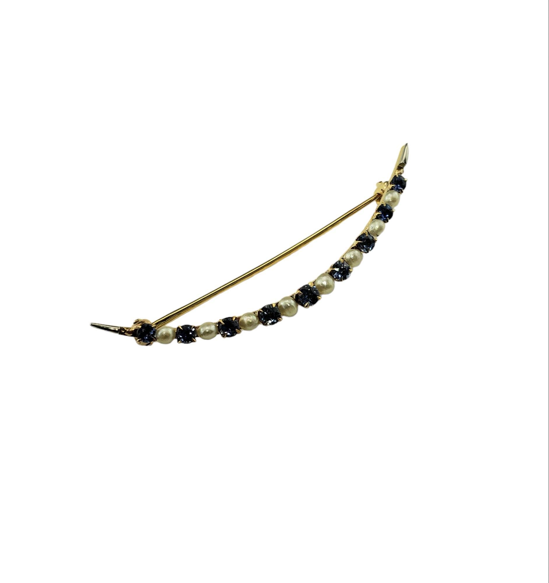 Vintage 14K Yellow Gold Sapphire and Seed Pearl Pin JAGi Certified-

This elegant pin features nine round blue sapphires and eight seed pearls set in beautifully detailed 14K yellow gold.  

Total sapphire weight: 1.26 ct.

Size: 2.1 in. 

Stamped: