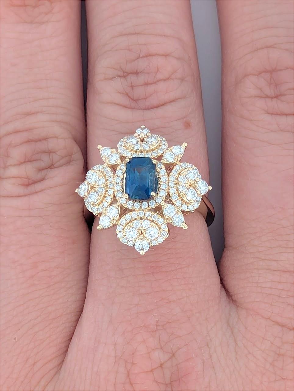 Make a bold statement with this 14K yellow gold cocktail ring, featuring a .95 CT natural Sapphire with a rich, deep blue hue. Accentuated by .95 CTW natural diamonds, this exquisite piece radiates brilliance and elegance. Designed for those who