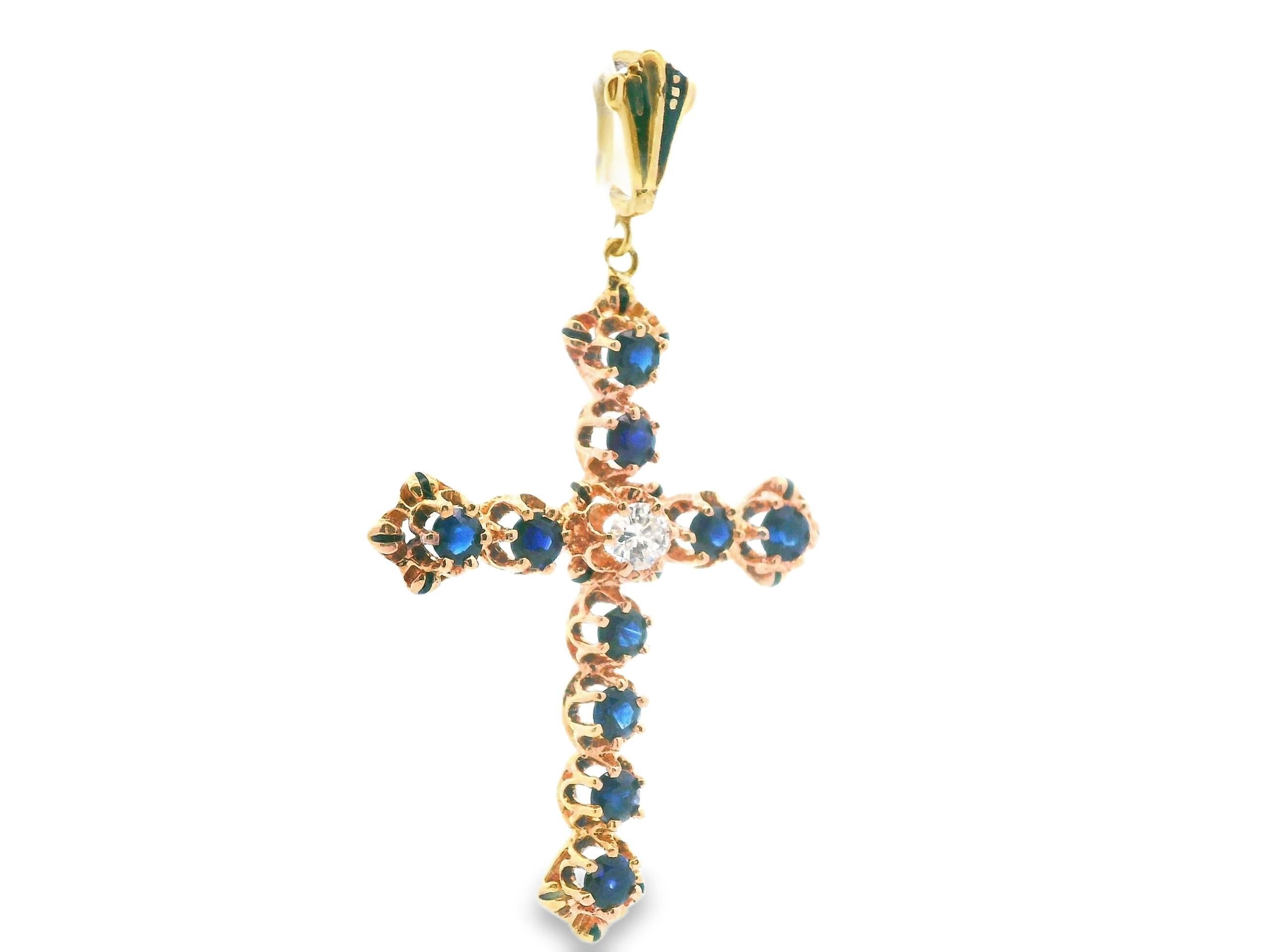 This incredible 14k yellow gold pendant is made with natural sapphires and a bright white diamond center. The single row of gemstones that form the cross feature enlarged ends with enamel accents that compliment the sapphire pendant beautifully,