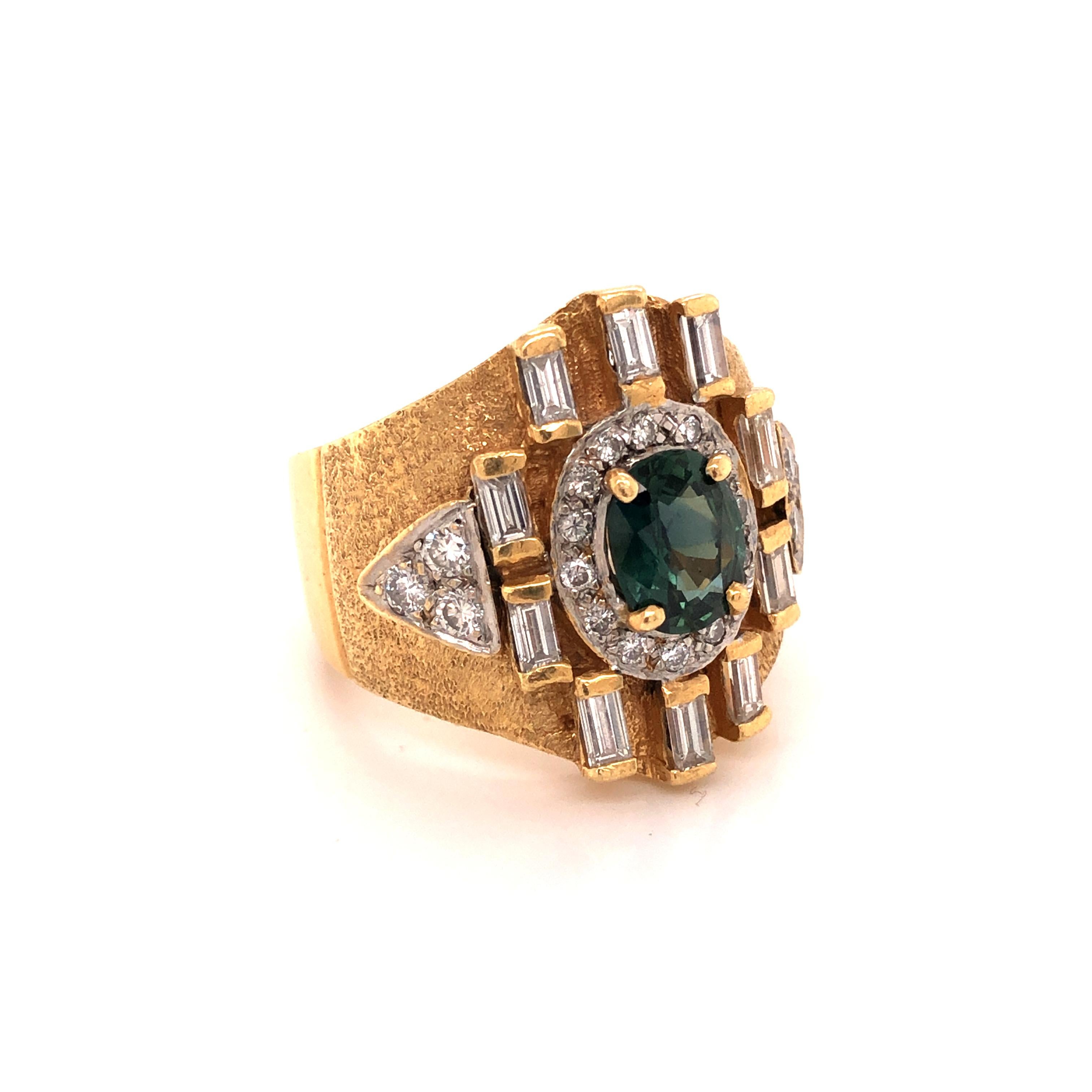 A 14K yellow gold ring featuring an oval-shaped bluish-green sapphire measuring 8.70 x 7.07 x 3.61 mm and weighing approximately 1.75 carats, enhanced by round-cut diamonds weighing a total of 0.55 carat and baguette-cut diamonds weighing a total of
