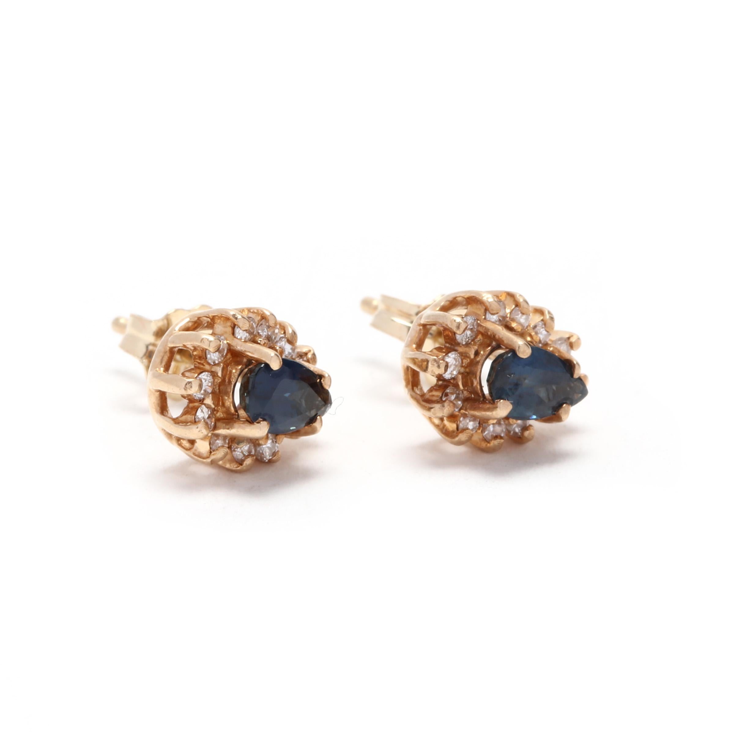 A pair of 14 karat yellow gold, sapphire and diamond stud earrings. These earrings feature prong set, pear shape sapphire center stones weighing approximately .60 total carats surrounded by a halo of full cut round diamonds weighing approximately