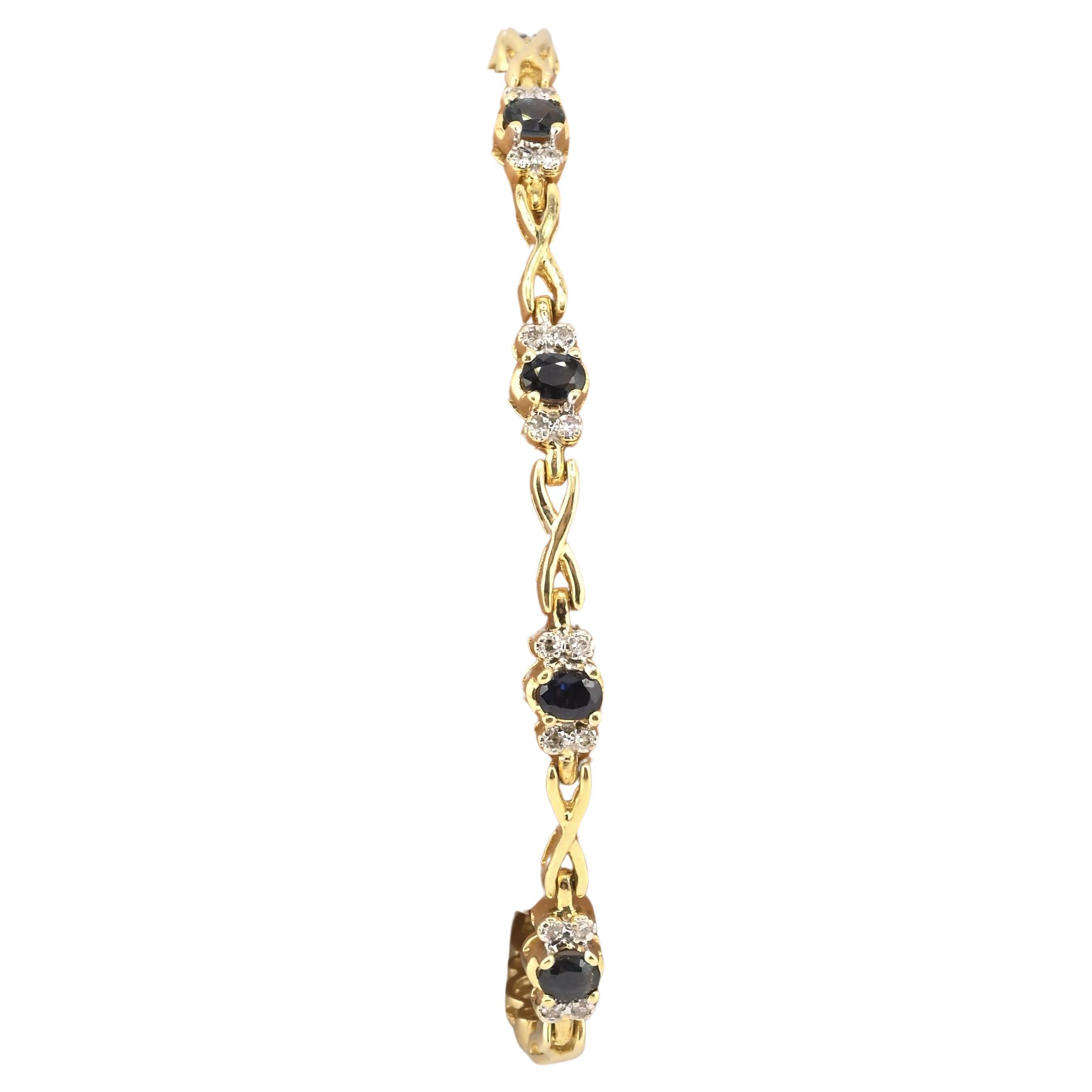 Elegant bracelet de tennis en or jaune 14K présentant une alternance d'or naturel et d'or blanc.  saphirs bleus et diamants naturels étincelants dans un design classique. Parfait pour les tenues de soirée ou pour ajouter une touche sophistiquée au