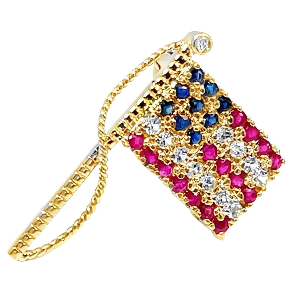 Spilla con bandiera tempestata di zaffiri in oro giallo 14k