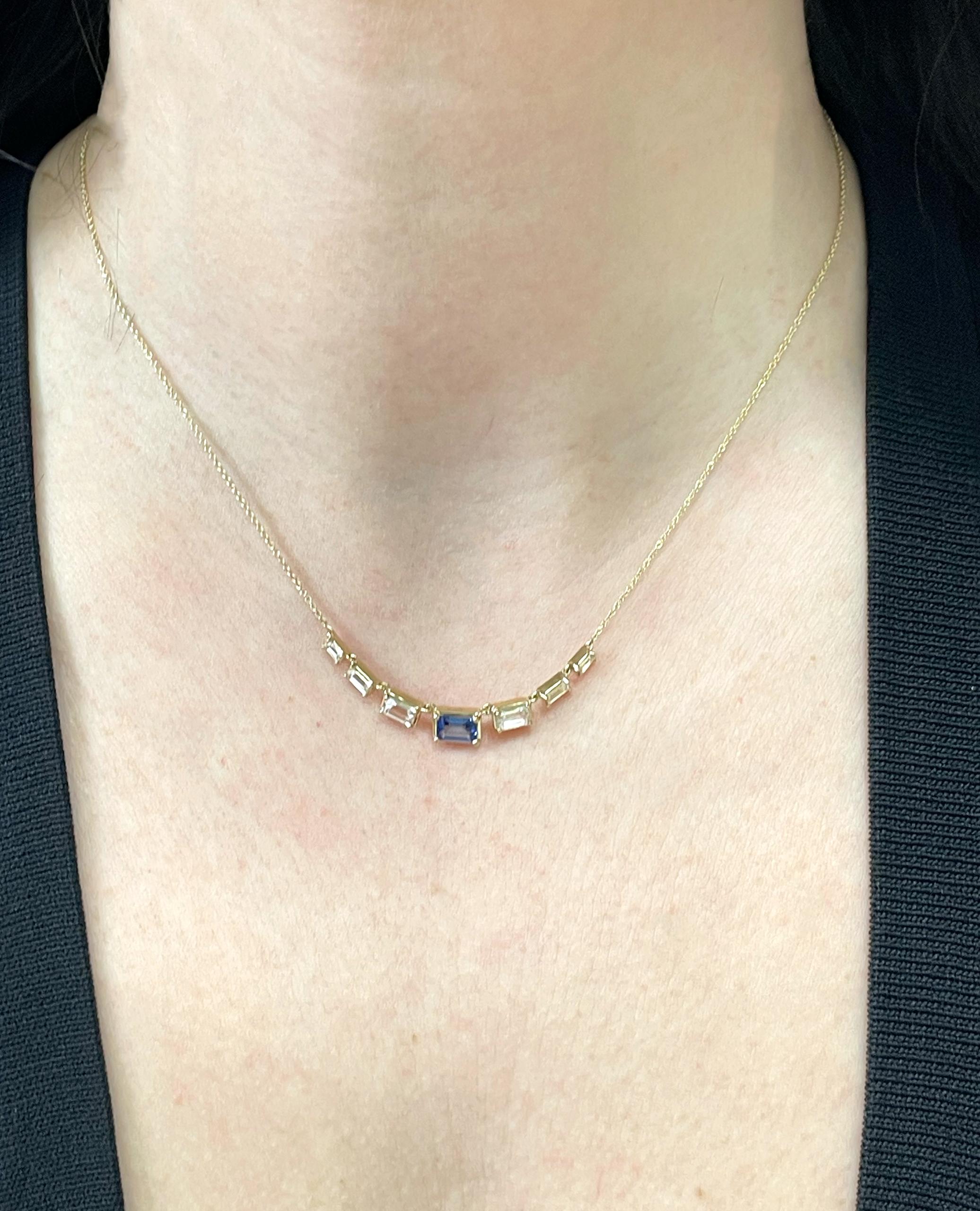 14K yellow gold seven station necklace with one center baguette blue/green sapphire weighing 0.67 carat and 6 baguette white topaz weighing 0.93 carat total. 

- Necklace is adjustable from 16-18 inches. 