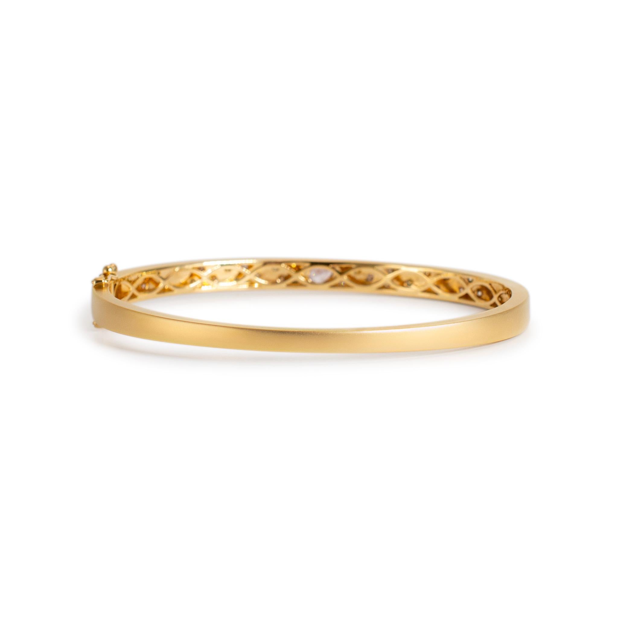 Gender: Ladies

Metal Type: 14K Yellow Gold

Length: 6.50 inches

Width: 5.00 mm tapering to 3.05 mm

Weight: 13.58 grams

One ladies satin finished 14K yellow gold, diamond bangle bracelet. The metal was tested and determined to be 14K yellow gold.