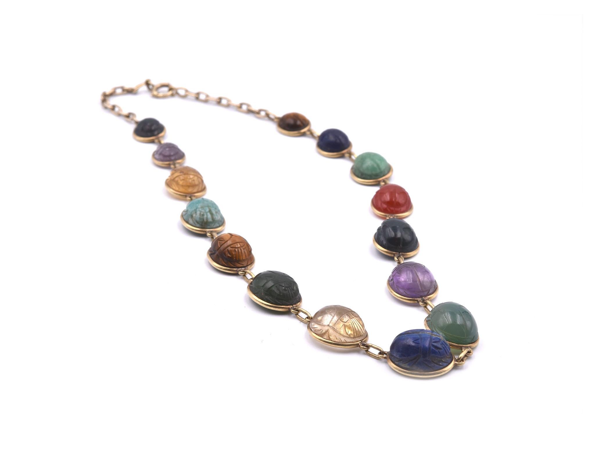 Designer: custom design
Material: 14k yellow gold
Semi-Precious Stones: branded onyx, goldstone, malachite, lapis, tigers eye, moon stone
Dimensions: necklace is 17 ½-inch long and it is 10.70mm-14mm wide 
Weight: 38.45 grams
