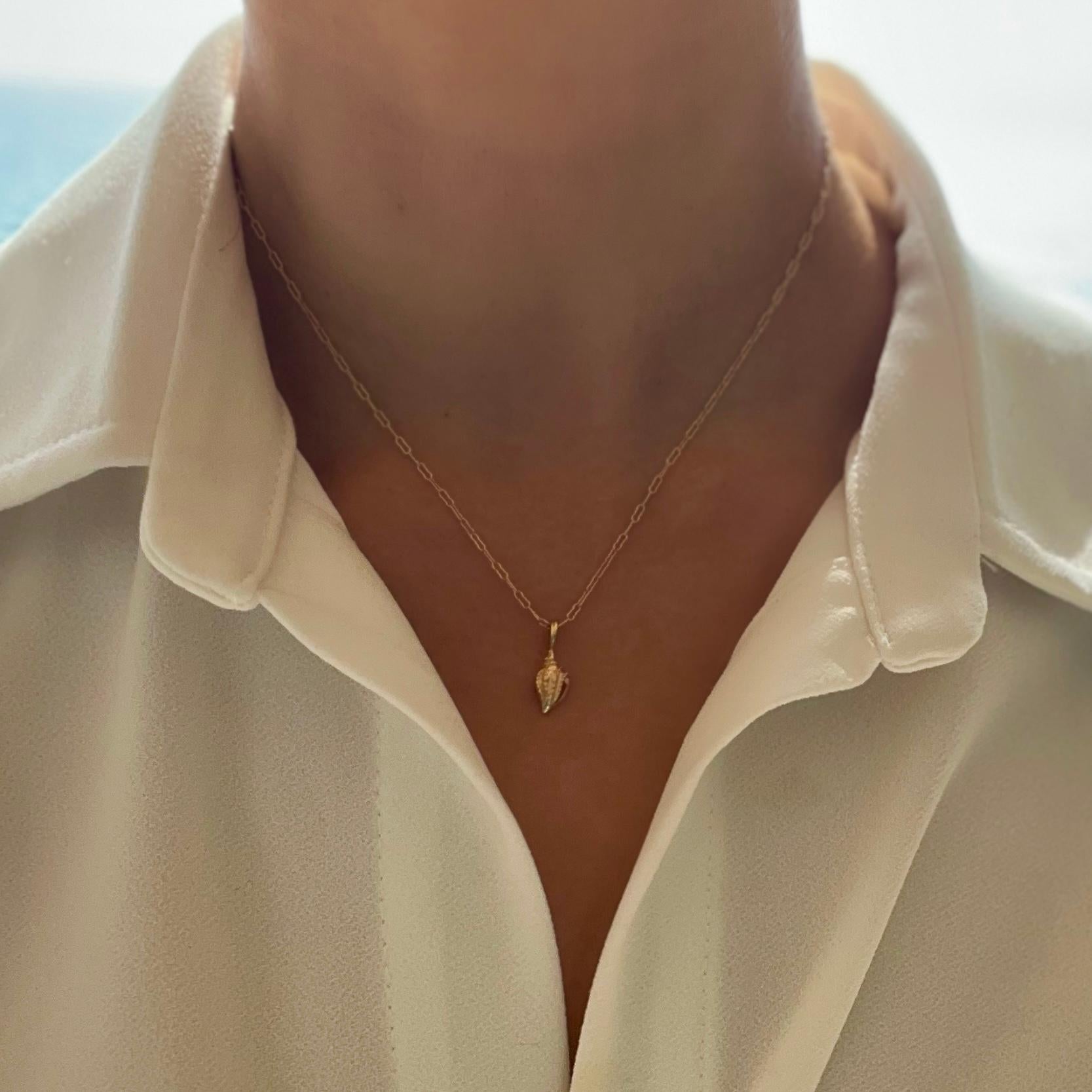 **This style is discounted as we have retired synthetic diamonds as a clasp option - last piece in stock.

A 14k gold seashell pendant paired with a custom hand-pavé double-sided synthetic diamond clasp and solid 14k textured paperclip chain. The