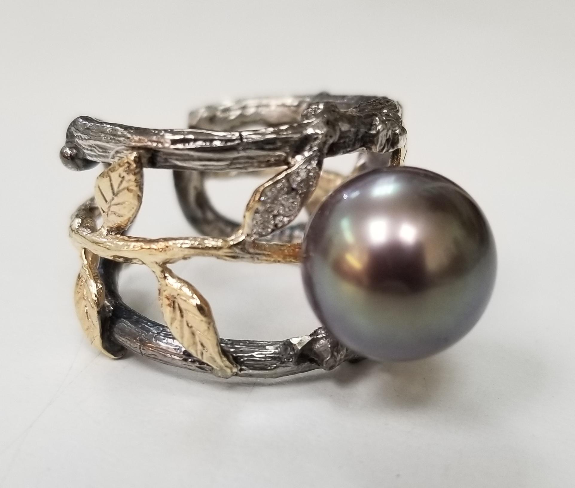 14k yellow gold and silver Gresha signature bark and leaf design with a 11.25mm brownish grey south sea pearl and 8 round diamonds weighing .10pts.  The ring is antiqued and is a size 7 with an adjustable bottom. 
*this design is ours and can be