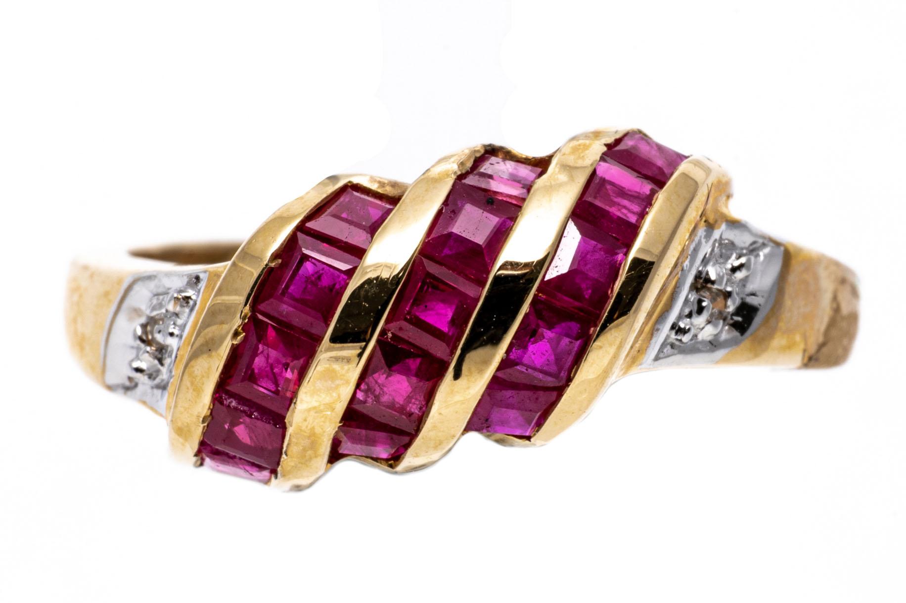 14k yellow gold ring. This pretty yellow gold ring is a slanted, swirl dome style, set with three rows of square faceted, dark pinkish red color rubies, approximately 1.05 TCW, channel set, flanked by round faceted diamonds, approximately 0.005 TCW,