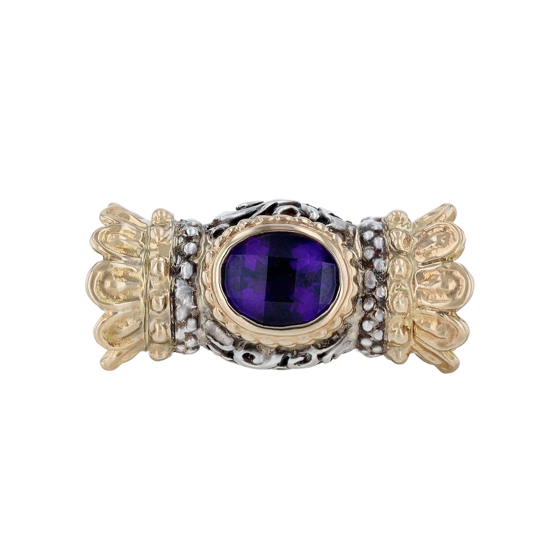 This collar necklace is made in sterling silver.  It features a slide pendant of 14K yellow gold with a center amethyst on one side and black onyx on the reverse side. 