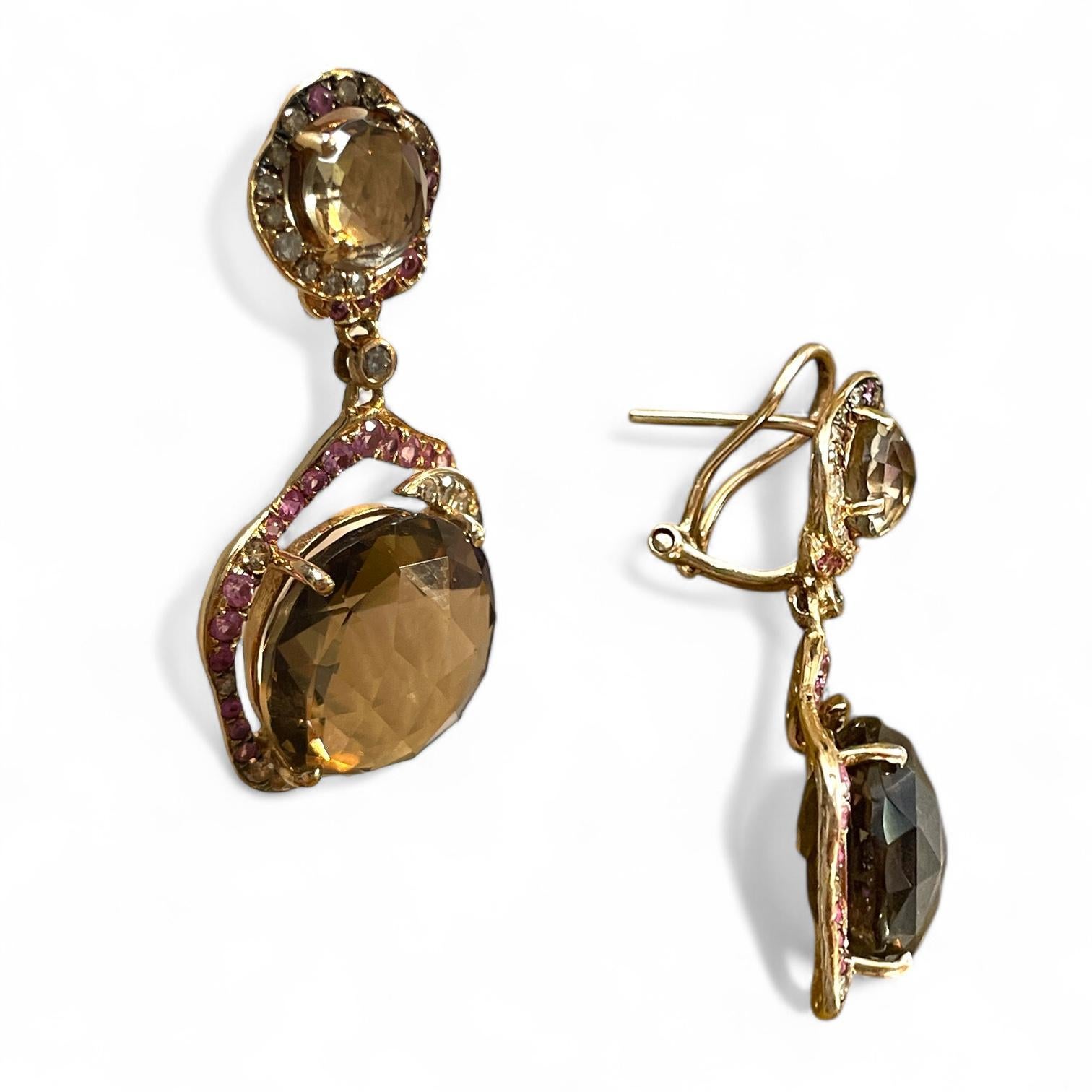 These elegant 14K yellow gold dangle earrings feature large, faceted smoky quartz gemstones framed by vibrant pink and yellow diamonds in a delicate floral-inspired design. The omega back clasp ensures both security and comfort. Reflecting the