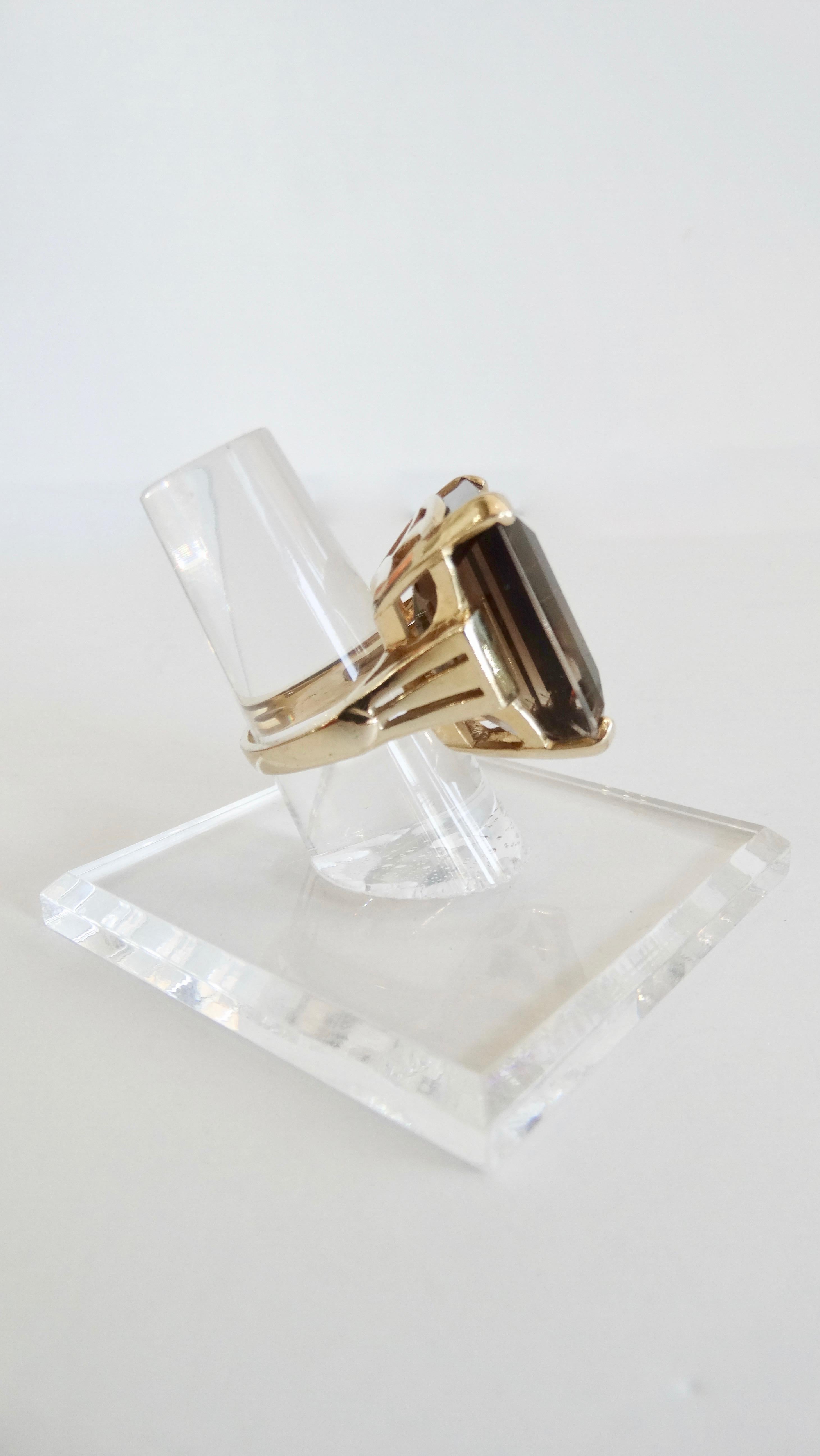 Gorgeous and timeless cocktail ring circa 1950s. Features a 35 carat smoky Quartz in a beautiful Emerald cut set in a 14k yellow Gold band.  Width at top measures 27mm, height measures 15mm and bottom width measures 4.54mm. 20.1 grams in weight and