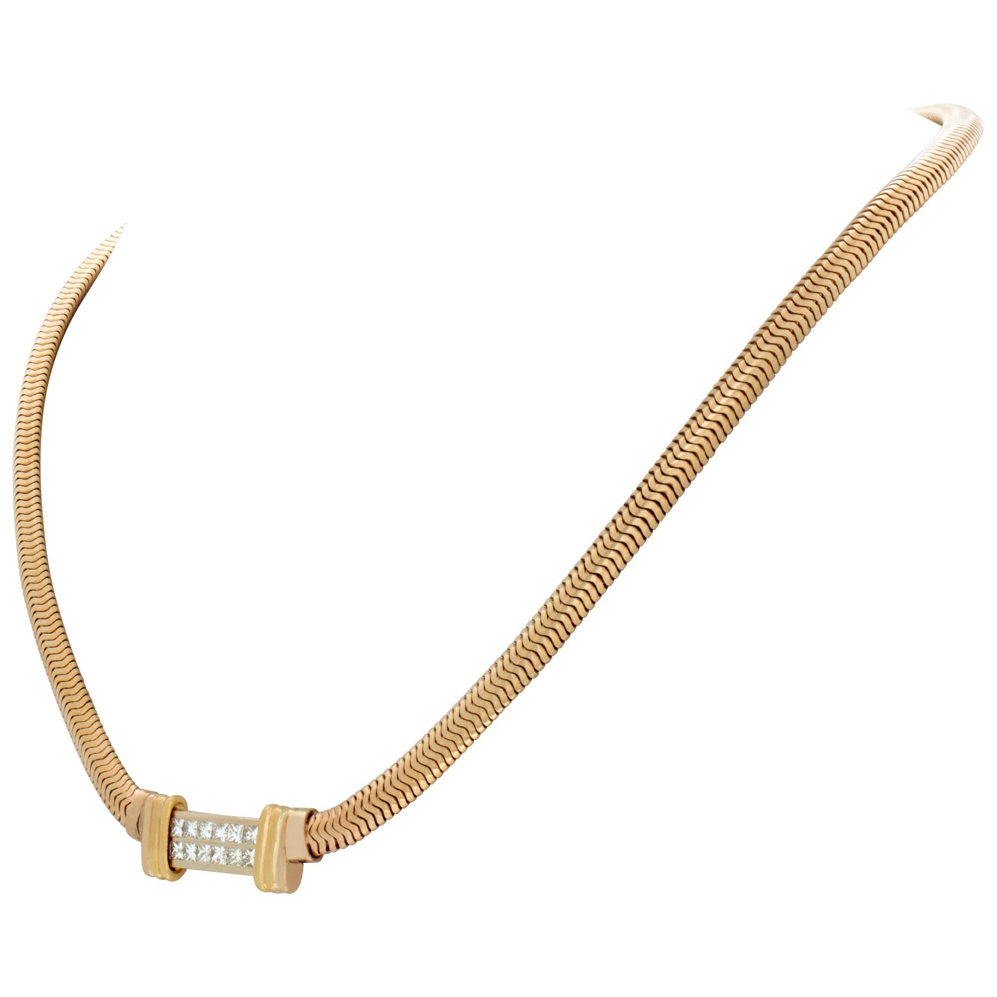 Snake link necklace in 14k yellow gold with a double row of approximately 1.20 carats in invisible set princess cut diamonds. 17 inch length.
