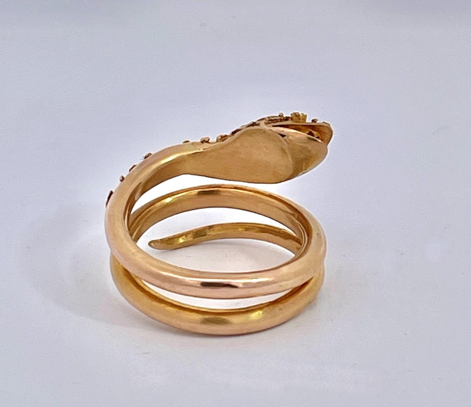 This snake ring is set in 14K Yellow Gold and is a size 6-6.5 and weighs 8.44 grams.  This snake is simple but it has an incredible detailed head and part of the body is granulated.  Granulation means the placing of small bits of gold to create a