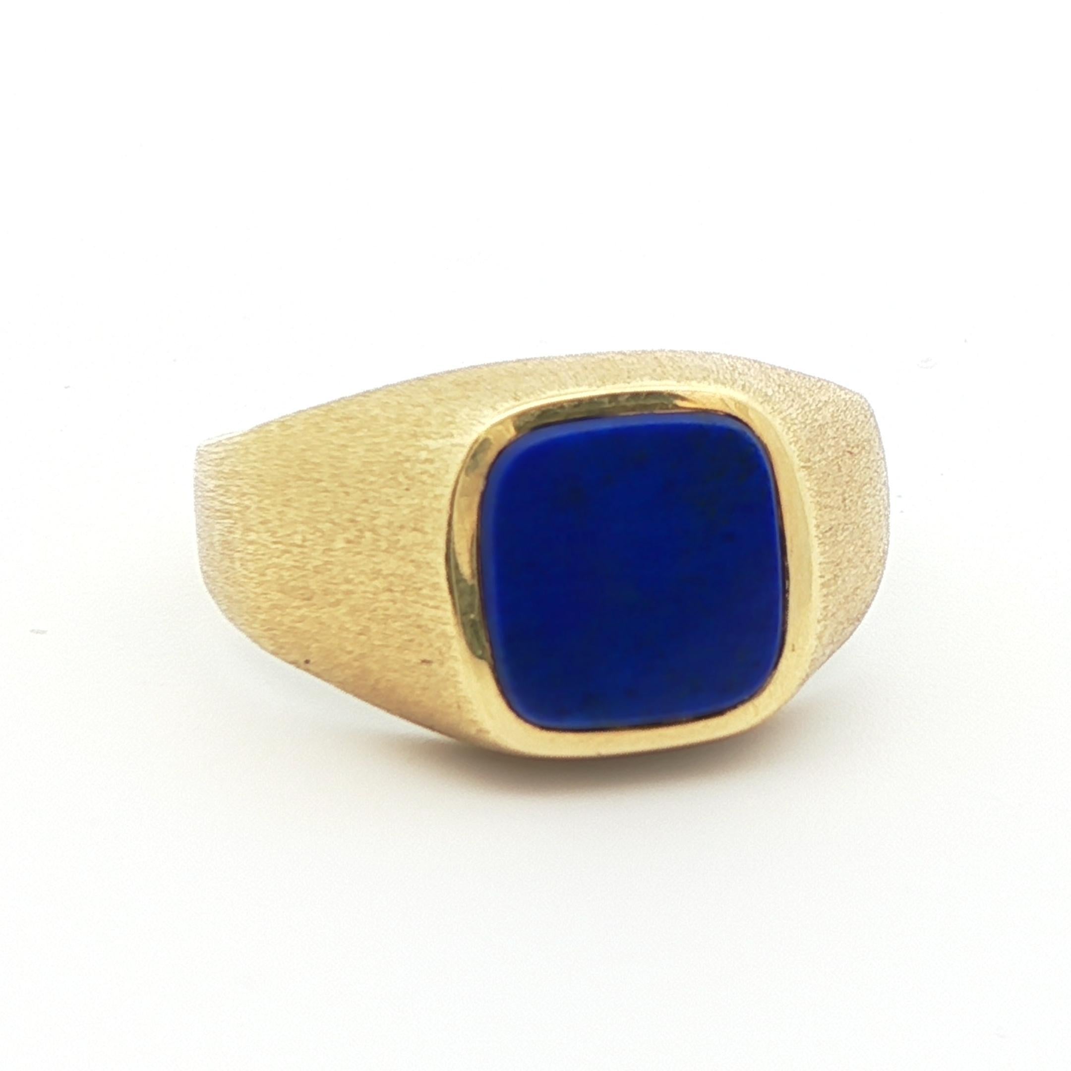 This stunning lapis ring is made in 14k yellow gold and features a flat natural blue lapis cushion that is resembles the starry night sky. The flat lapis perfectly pairs with the sturdy bezel setting, which is known for being one of the most