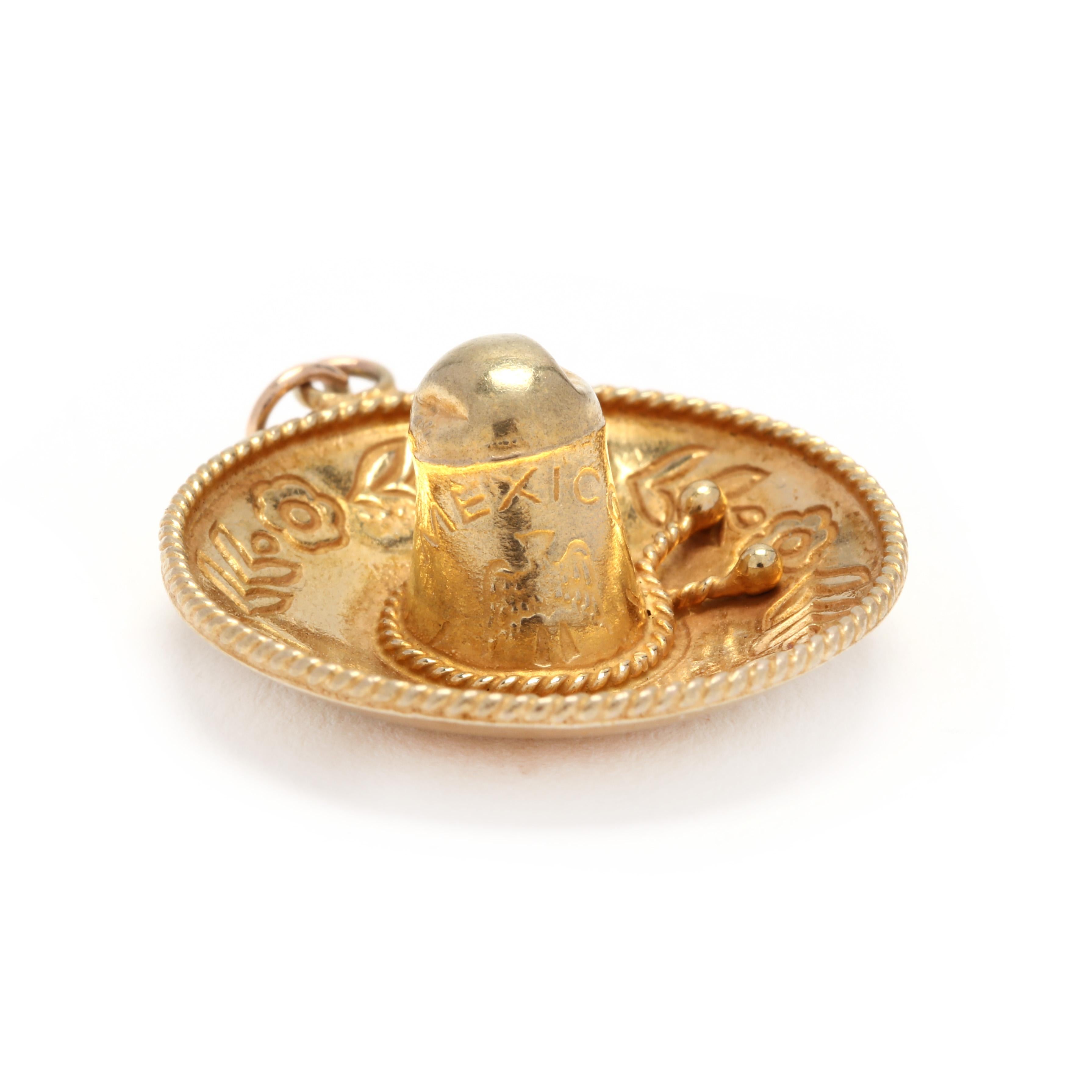 A 14 karat yellow gold sombrero charm / pendant. This charm features a sombrero hat motif with floral engraved detailing and rope motifs.

Length: 1.25 in.

Width: 7/8 in.

2.16 dwts.

* Please note that this is a vintage item and may show signs of