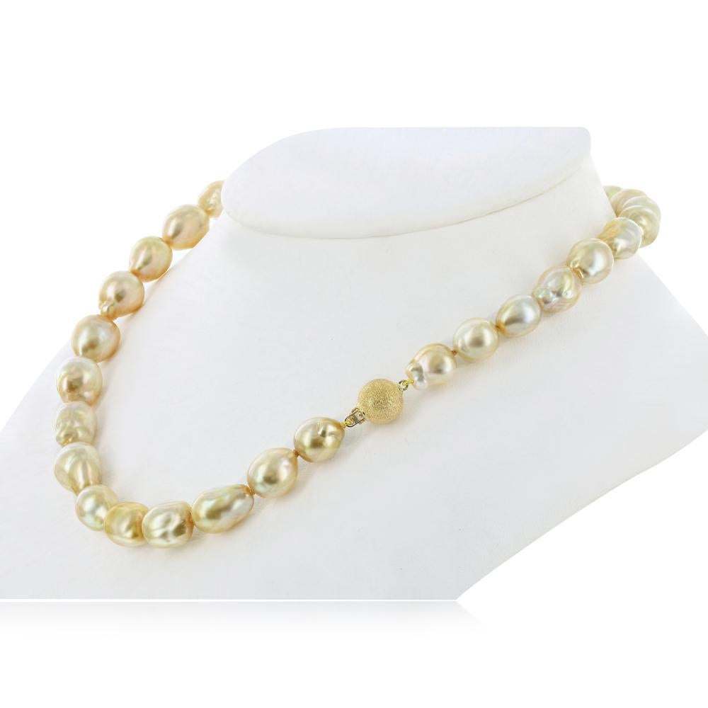 This natural color South Sea Golden Baroque pearl necklace features fine quality, high luster 12x13mm pearls. The necklace is strung to 18 inch length with a beautiful 14K Yellow Gold clasp. 
Featuring high quality, natural-color golden pearls, this