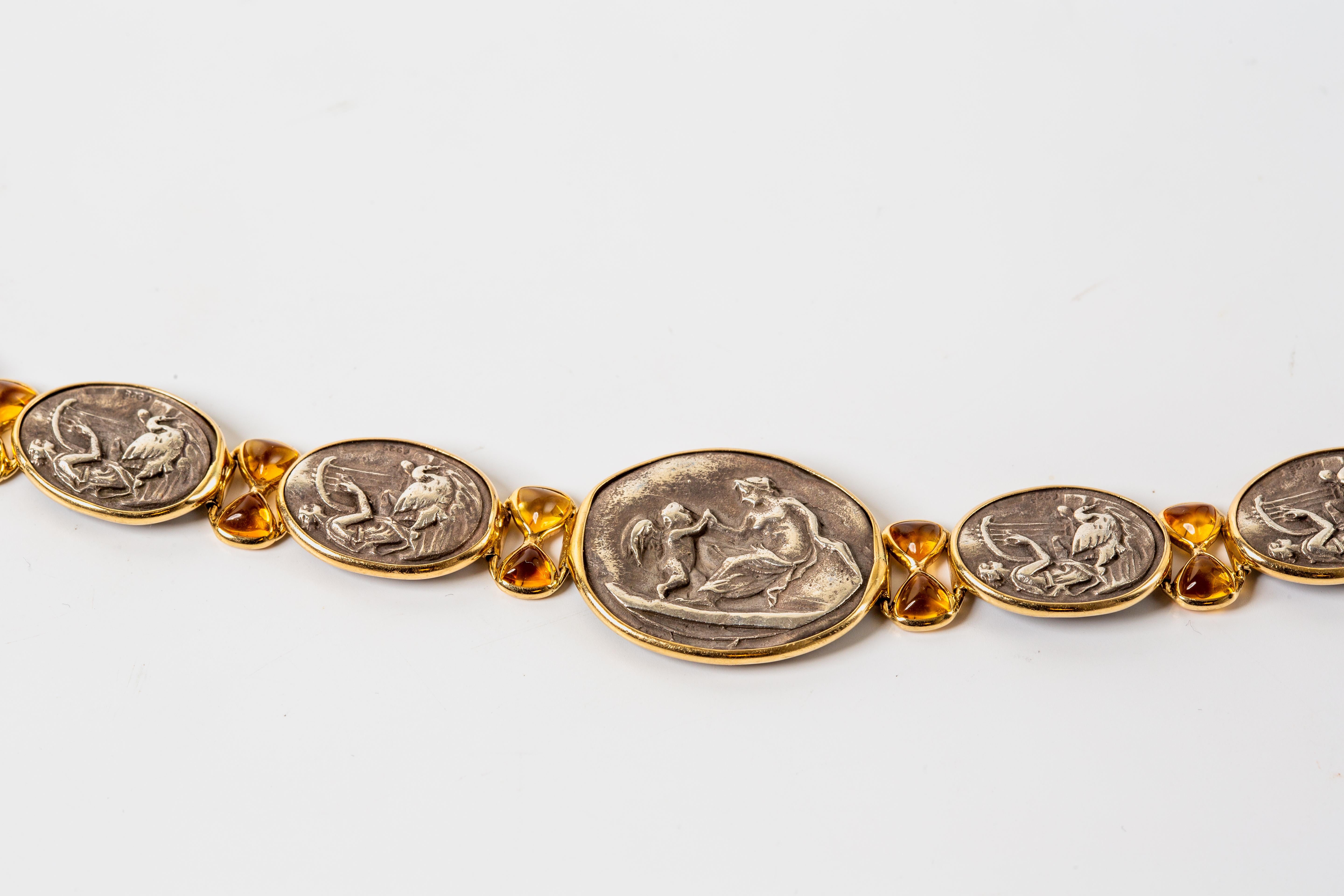 Material: 14k Yellow Gold & Sterling Silver
Gemstone: Citrine Cabochon 5 x 4.95 mm
Weight: 25.4 grams
Length: 7 7/8 inches
Dimensions: 22.2 x 28 mm - middle medallion
14.6 x 19.2 mm - side medallions

14k yellow gold and sterling silver ancient