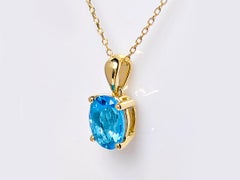 14K Yellow Gold Swiss Blue Topaz Oval Cut Solitaire Pendant