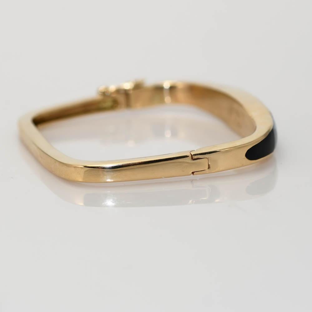 Ladies 14k yellow gold bangle bracelet with black onyx and lab grown opal.
The bracelet tests 14k and weighs 26.3 grams gross weight.
The opal and onyx is set in a channel setting.
The bangle measures 6 1/2 inches long on the inside and 19mm wide at